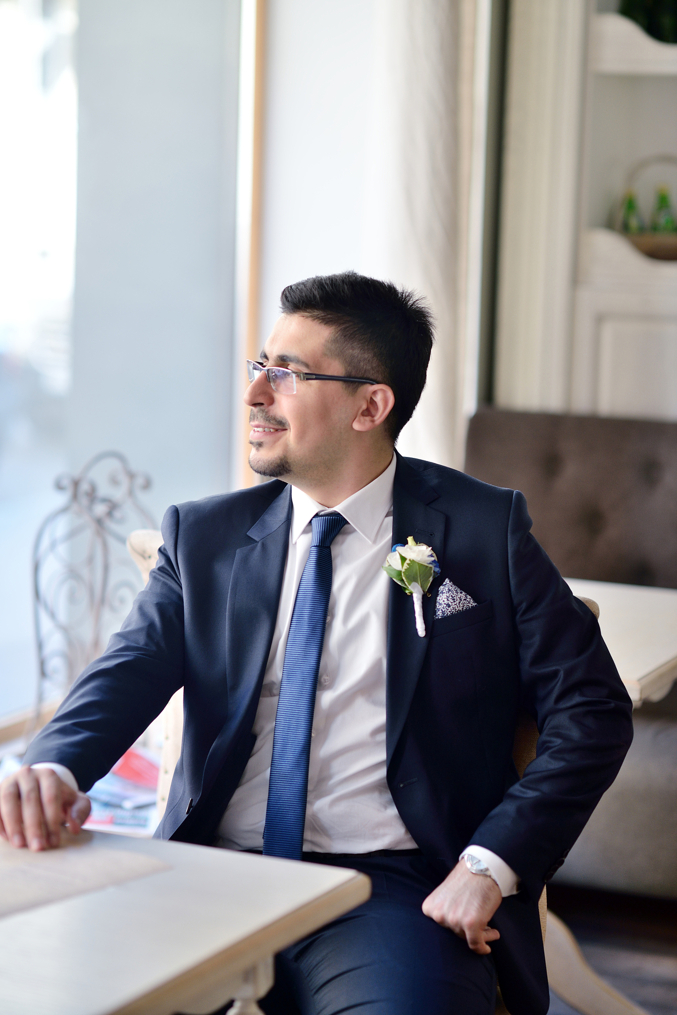 handsome groom in suit in the hall