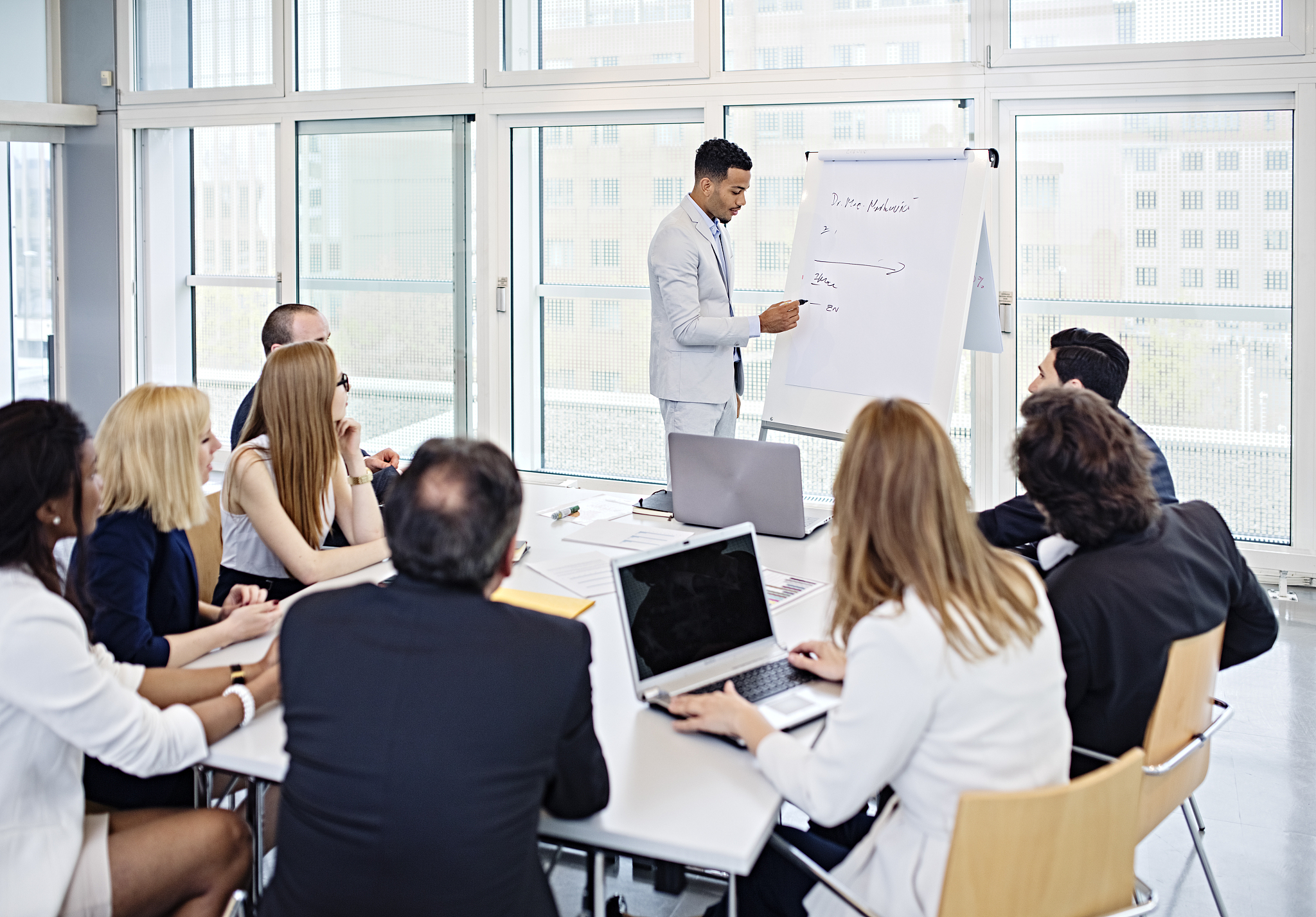 group of office workers in a boardroom presentation