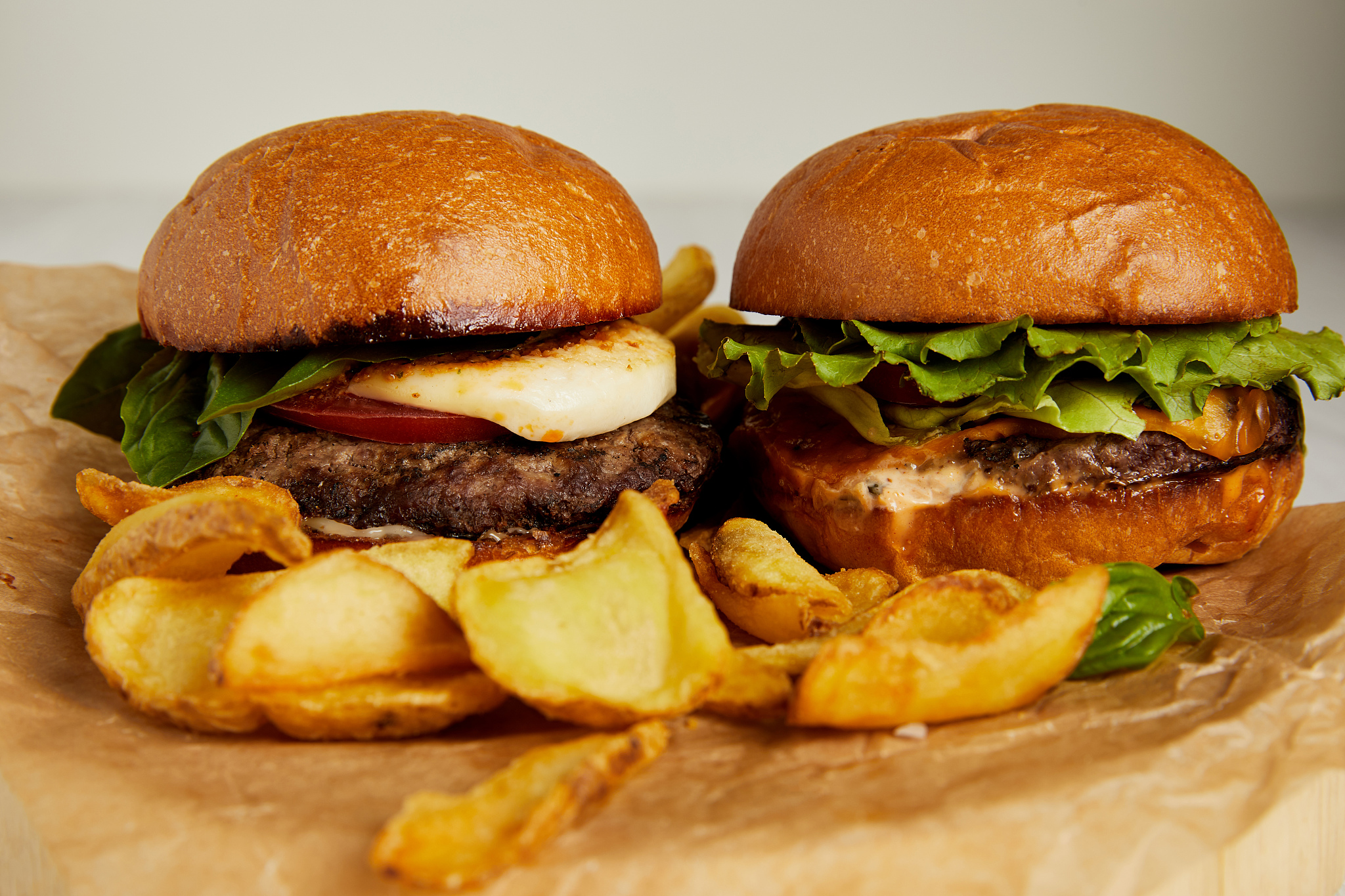 junk food concept with burgers and fried potatoes on craft paper