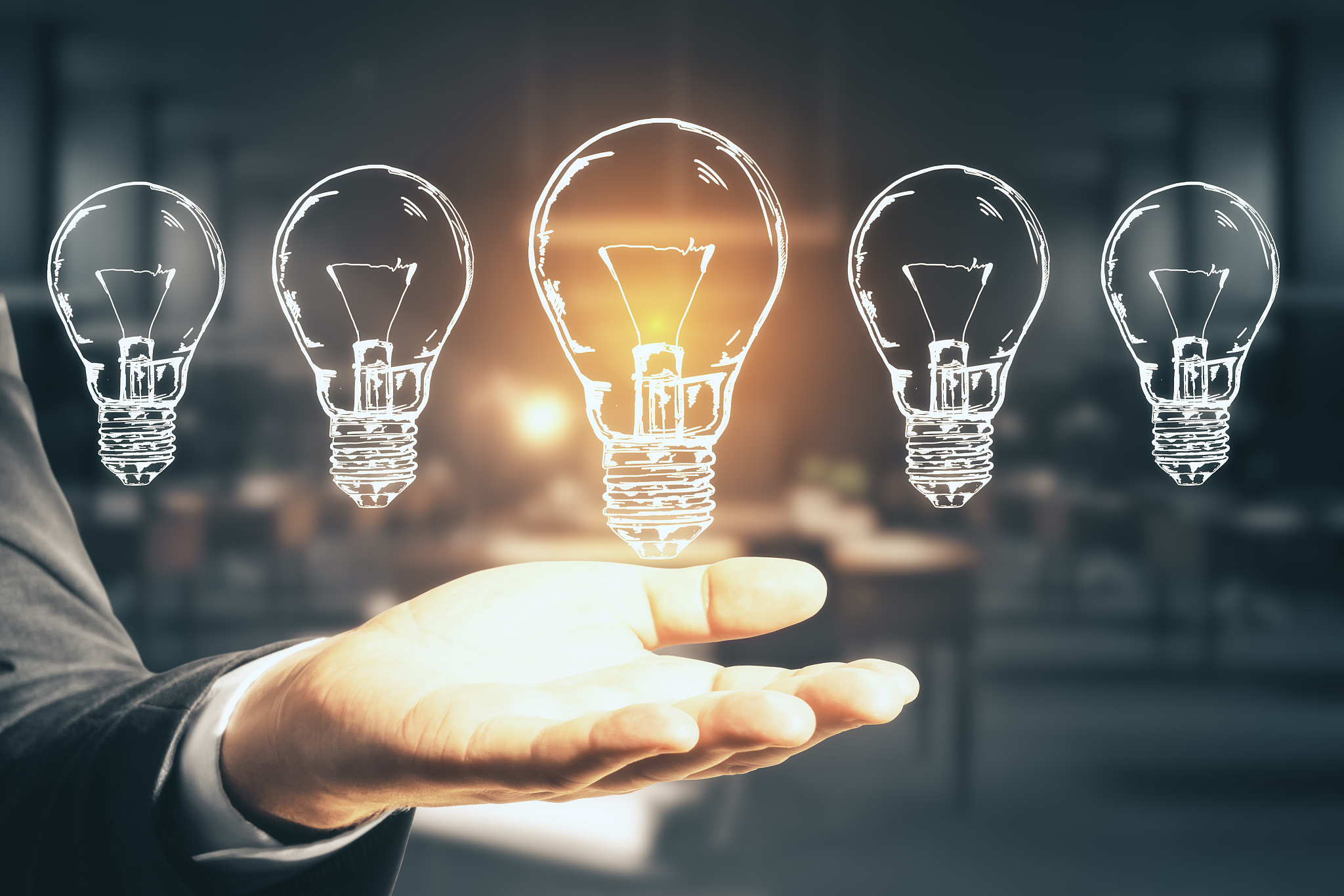 businessman hand holding five drawing abstract light bulbs.