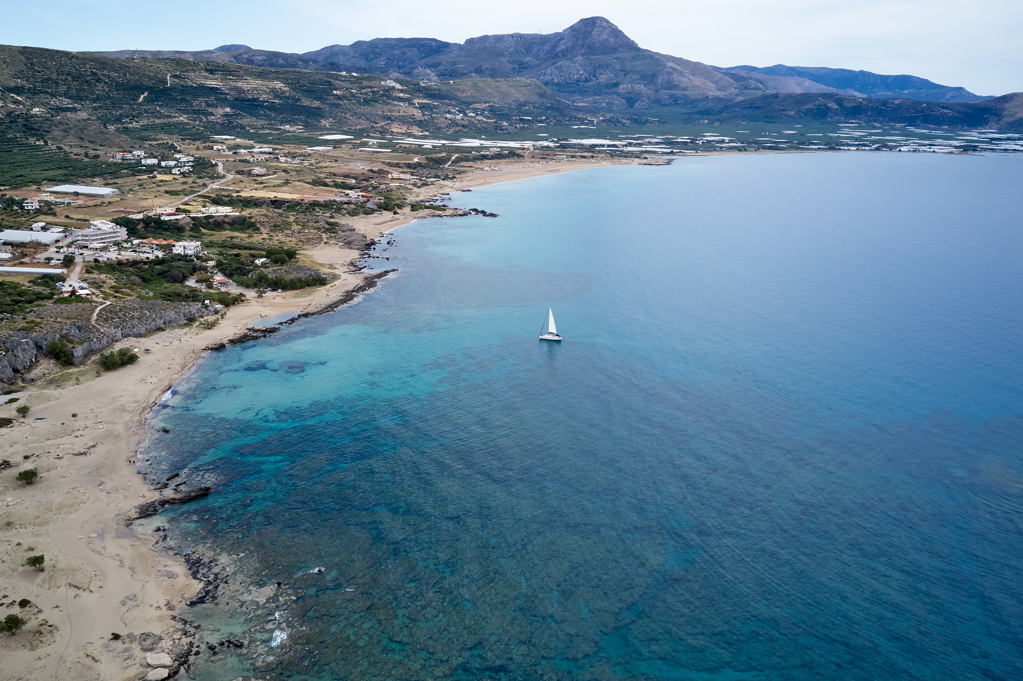aerial drone photo of luxury sail boat cruising in the deep blue