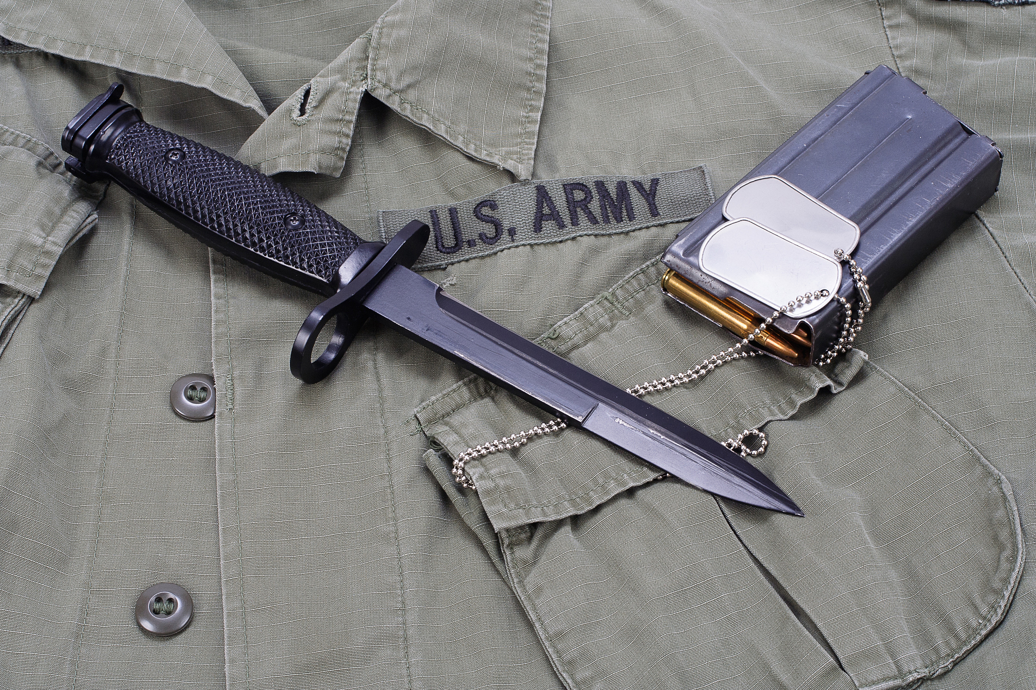 m16 rifle bayonet on uniform background