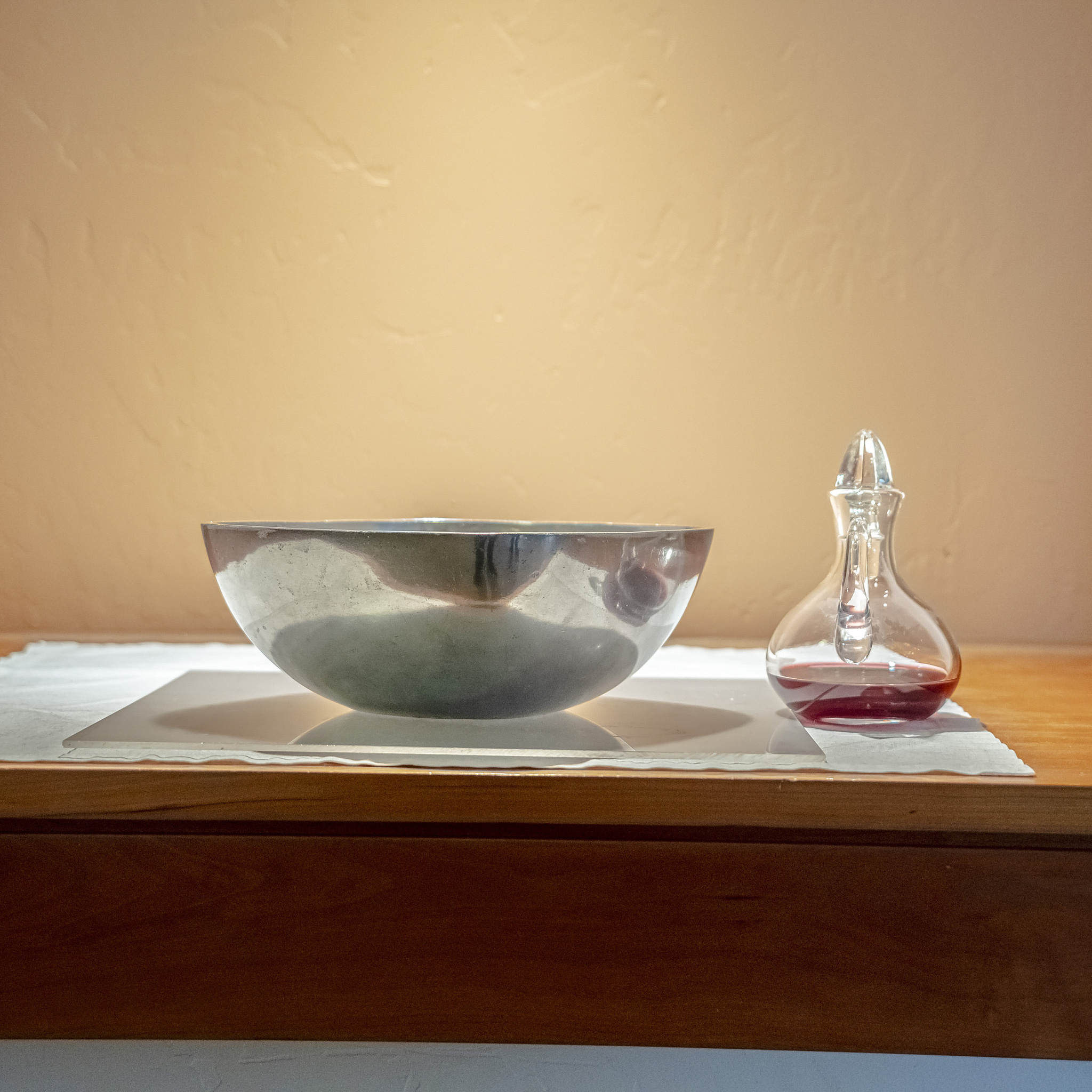 square frame communion wine and wafers inside a church