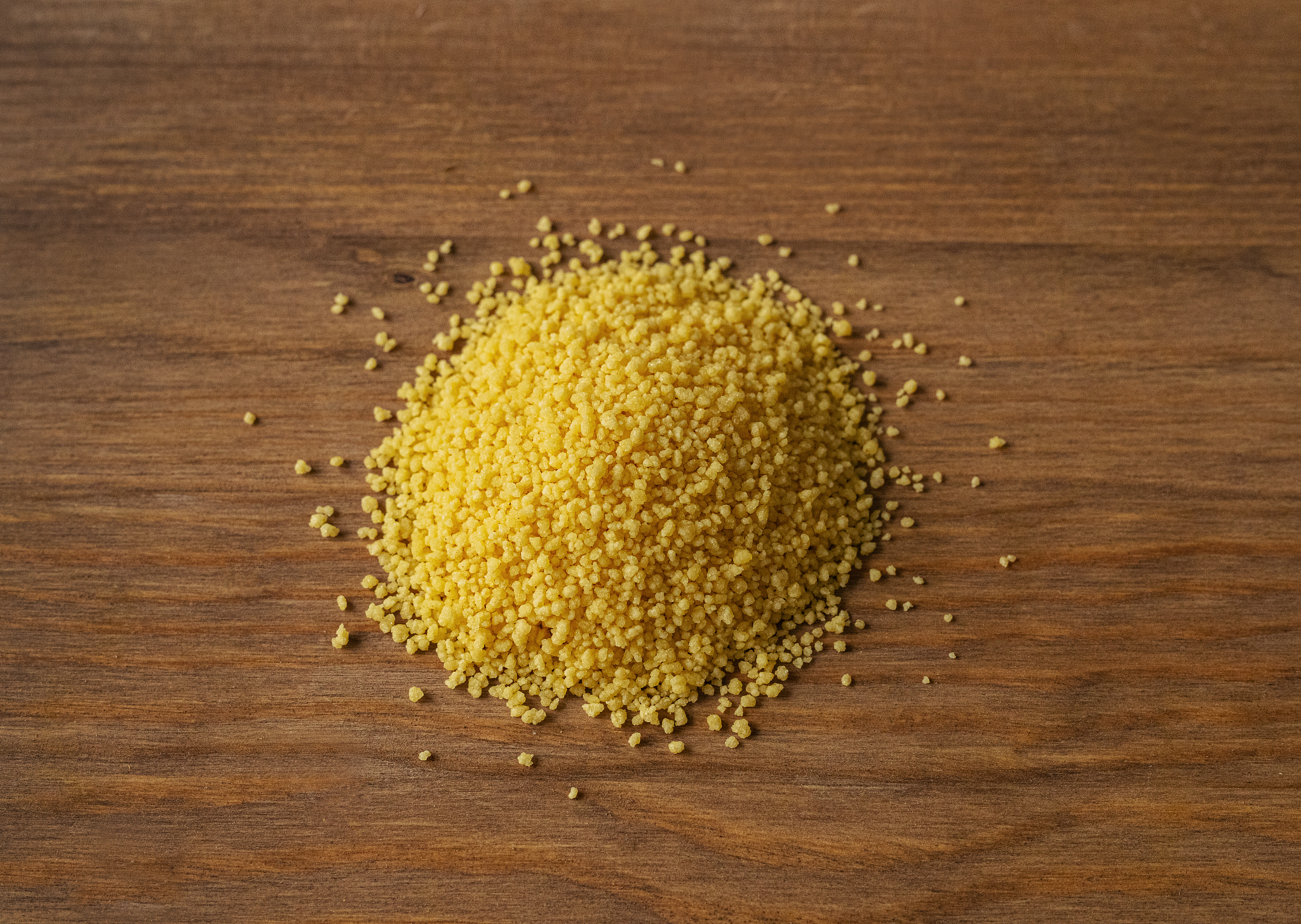 dry couscous grain on wood background, food, diet, healthy food,