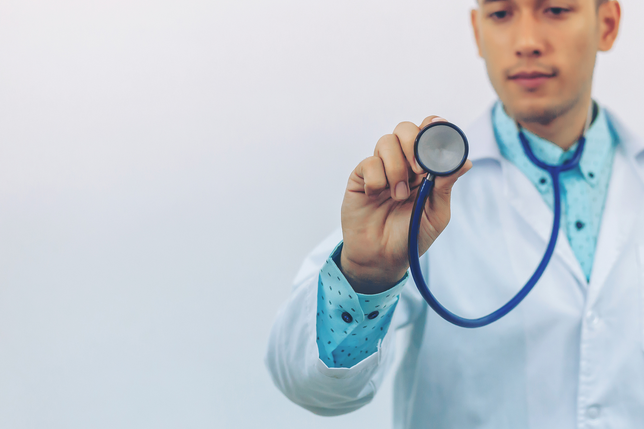 asian young doctor show stethoscope for treatment patient at hos