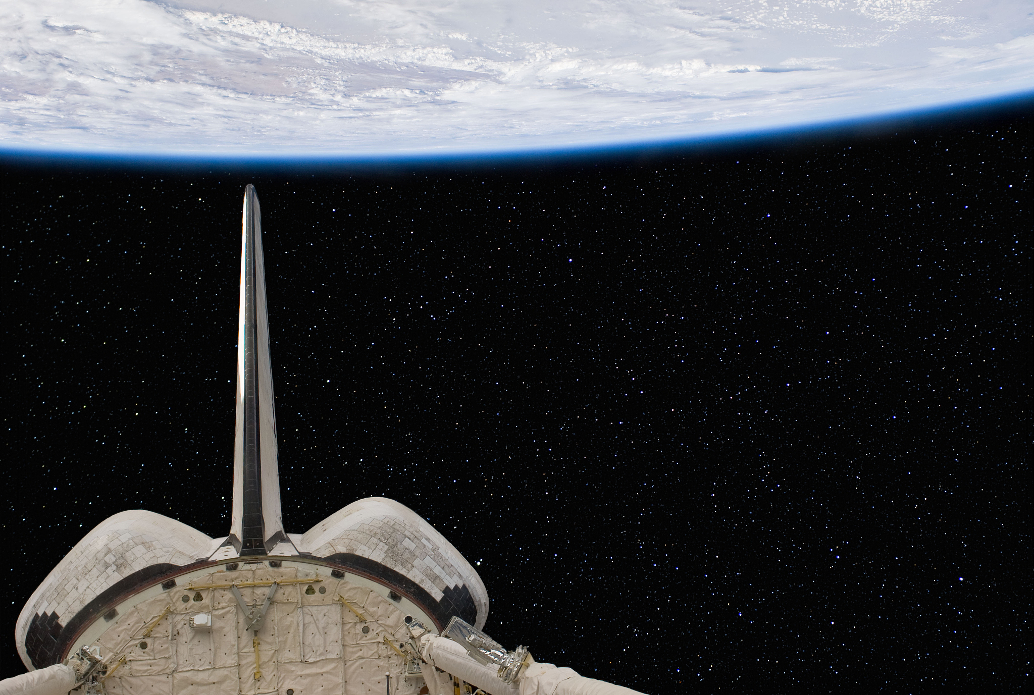 space shuttle above the earth.