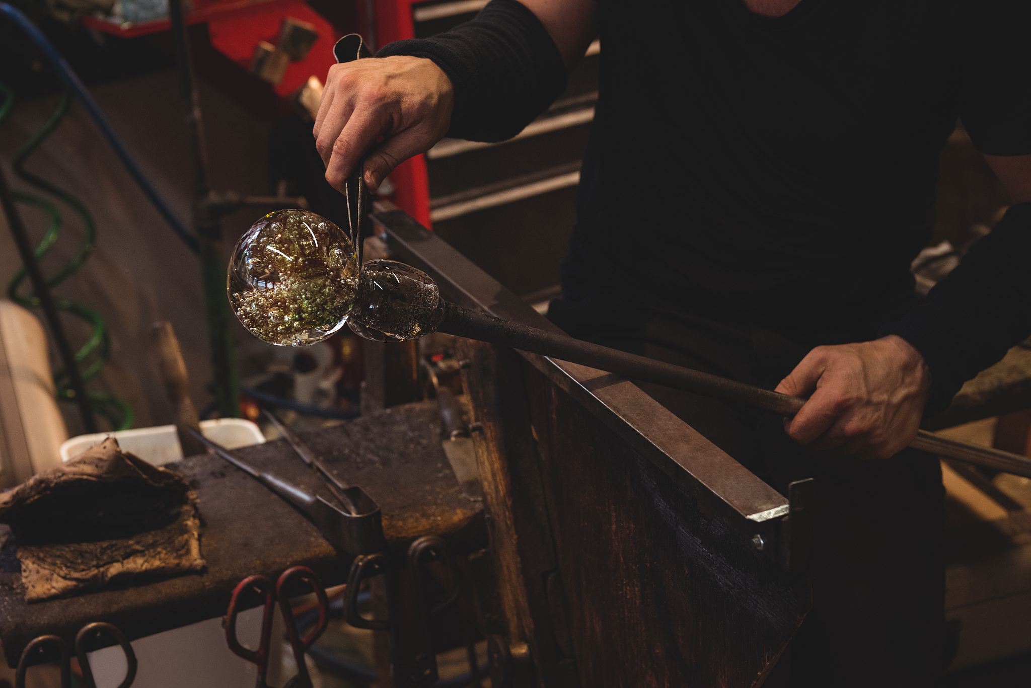 glassblower shaping a molten glass