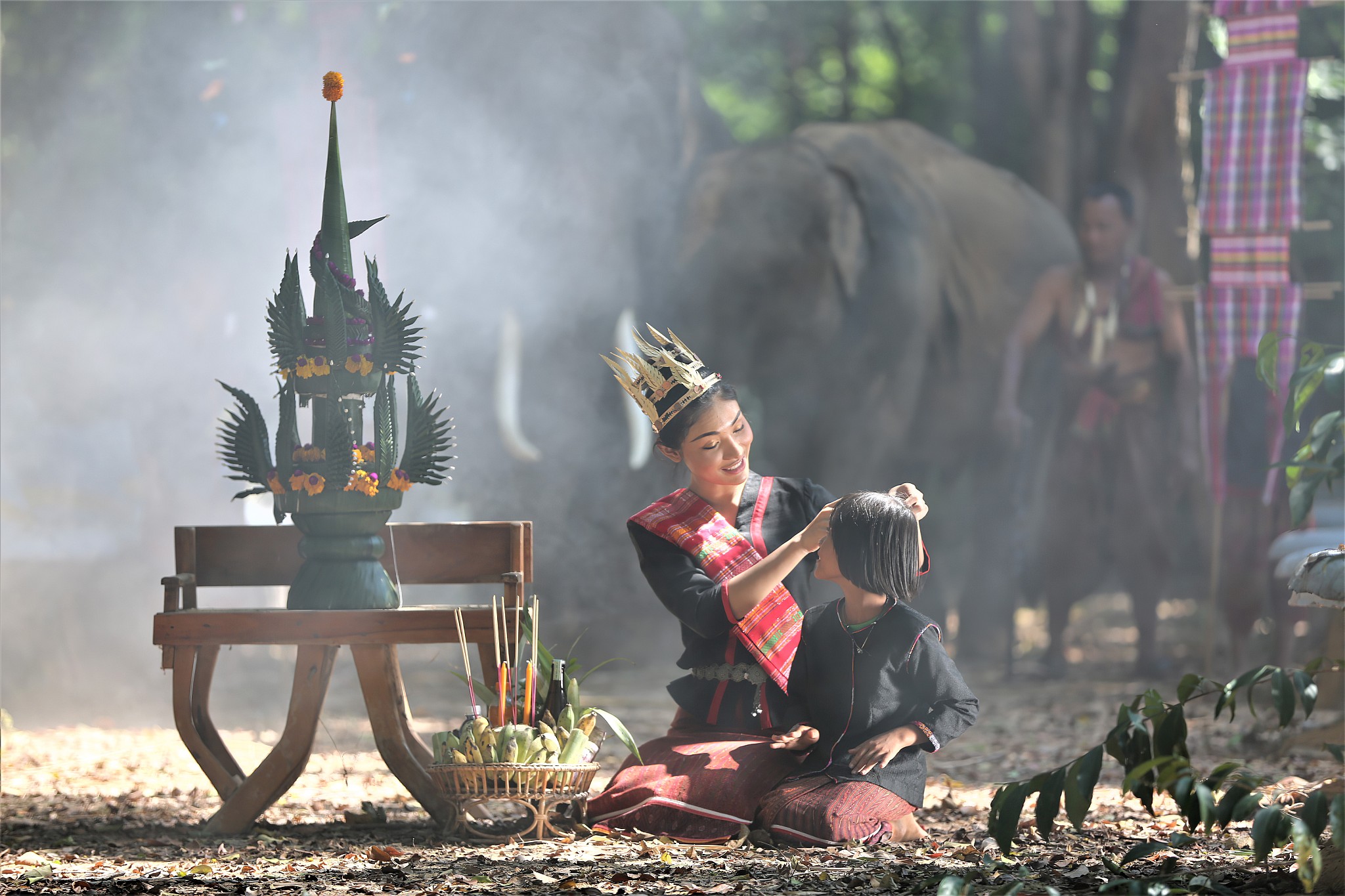 woman sitting with girl by decoration