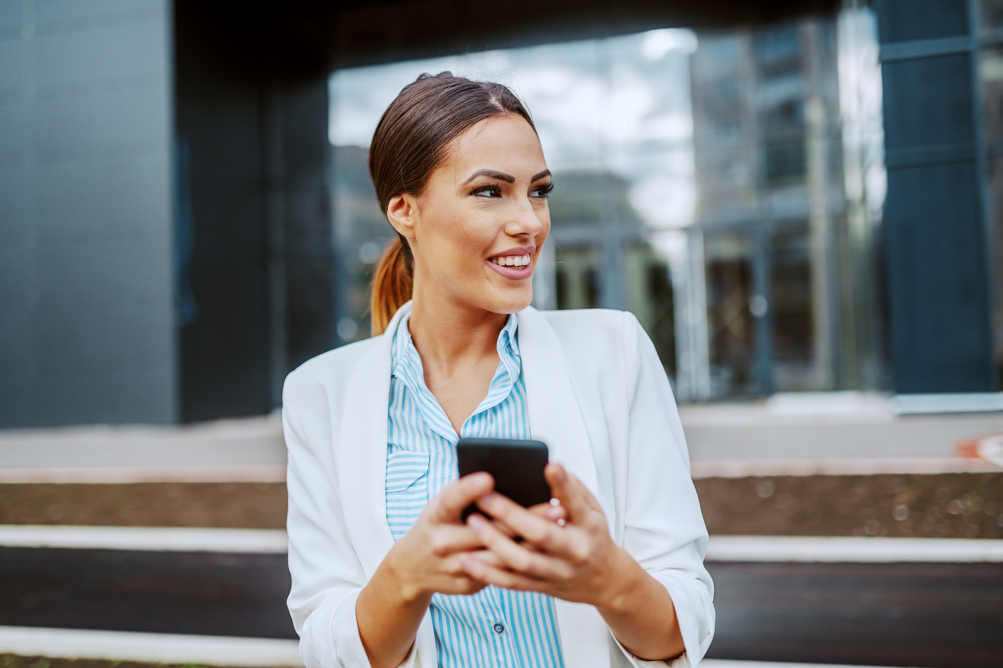 young attractive smiling stylish businesswoman standing in front