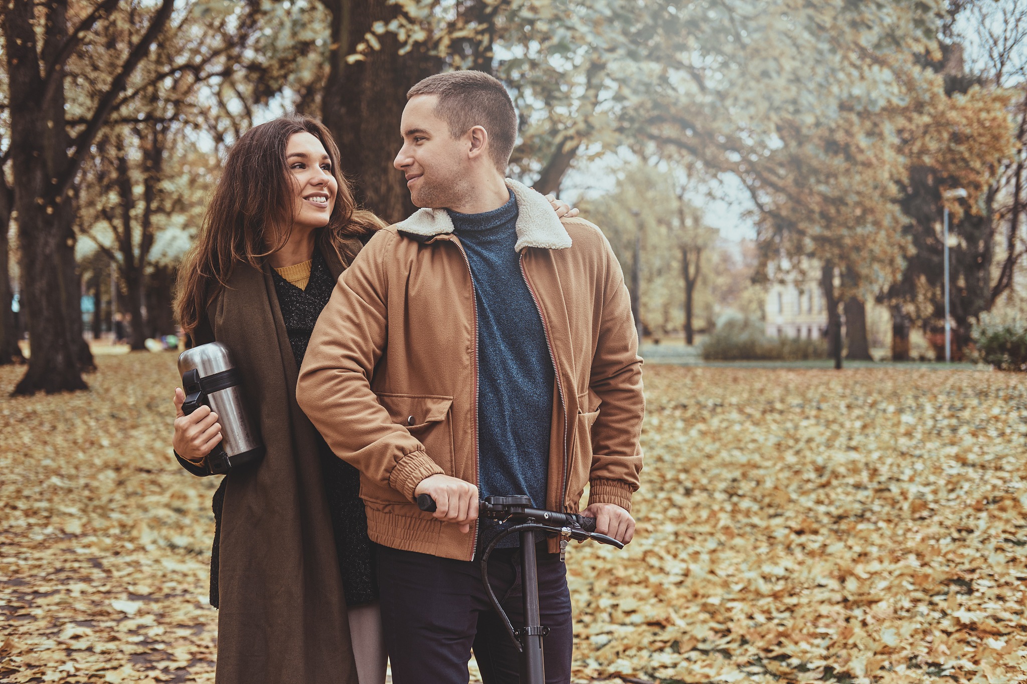 scooter riding at autumn park