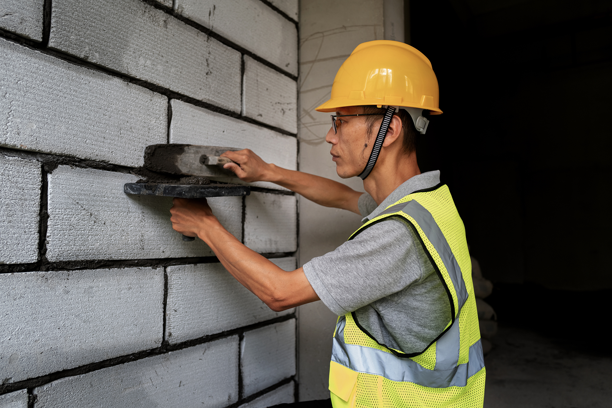asian middle-aged male construction worker at construction site