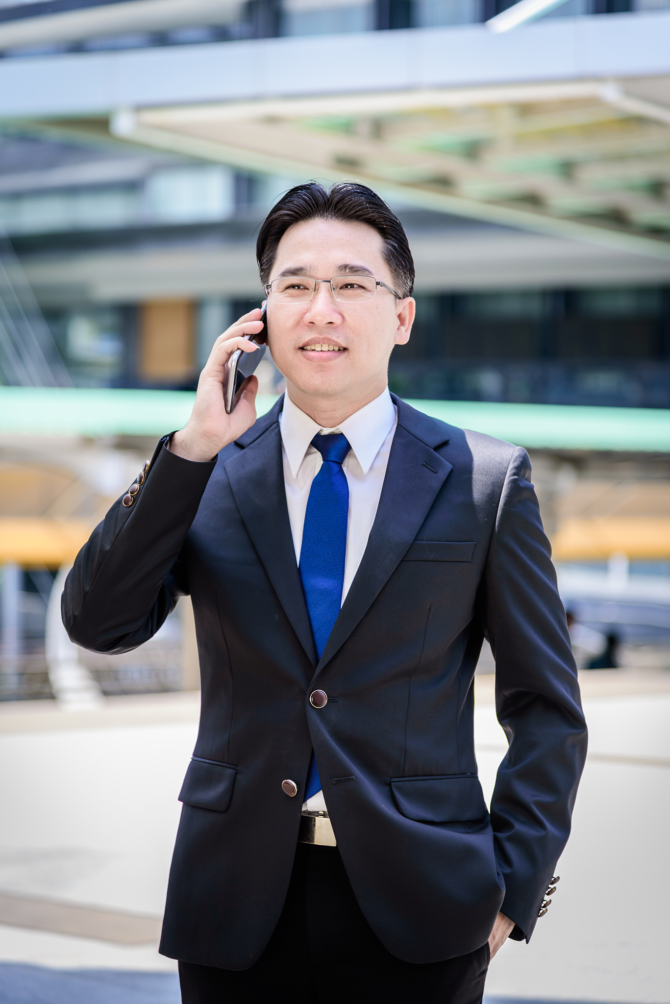 the asian businessman has working on mobile with happy.