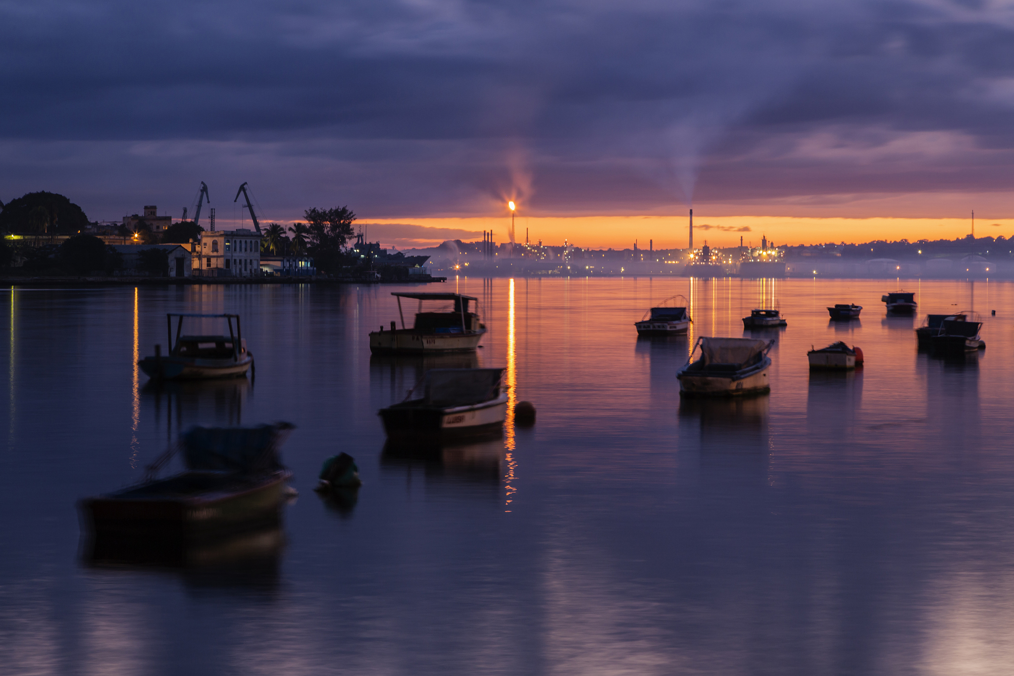 boats floating in havana harbor at sunrise, havana, cuba