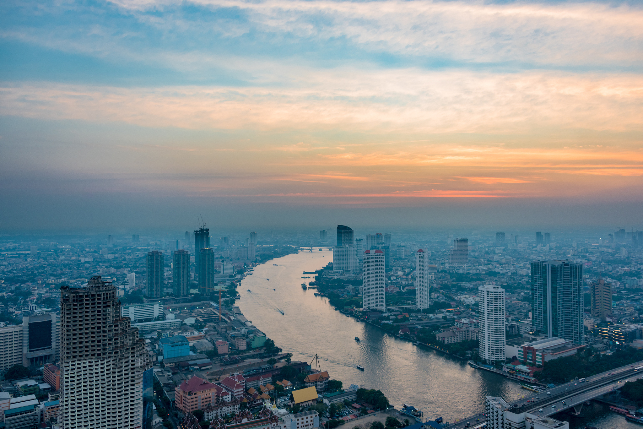aerial view of bangkok cityscape with chao phraya river at sunse