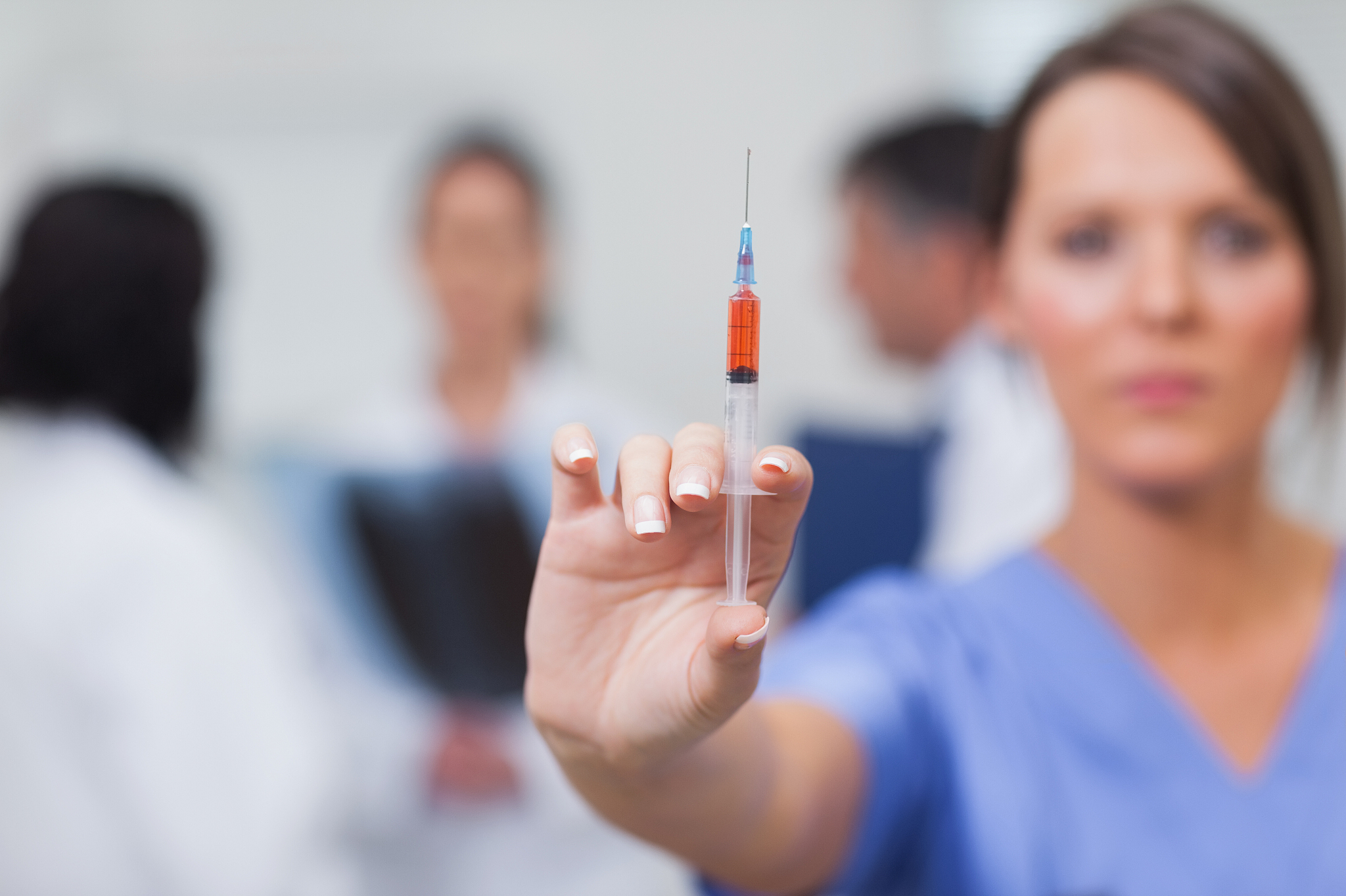 nurse showing syringe