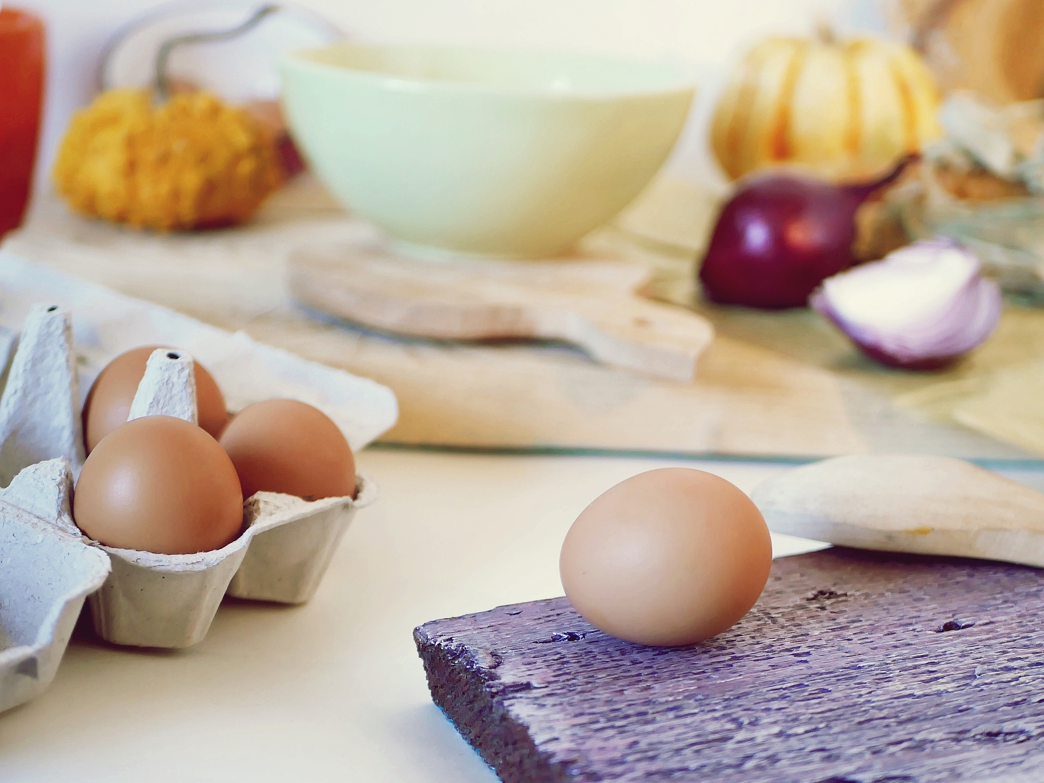 eggs, pumpkins, onions, vegetables, sea salt on a light table