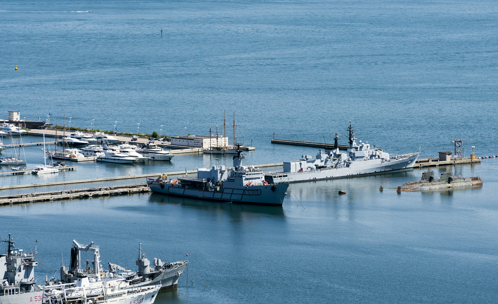 view of the military, commercial dock and ships with mountains o