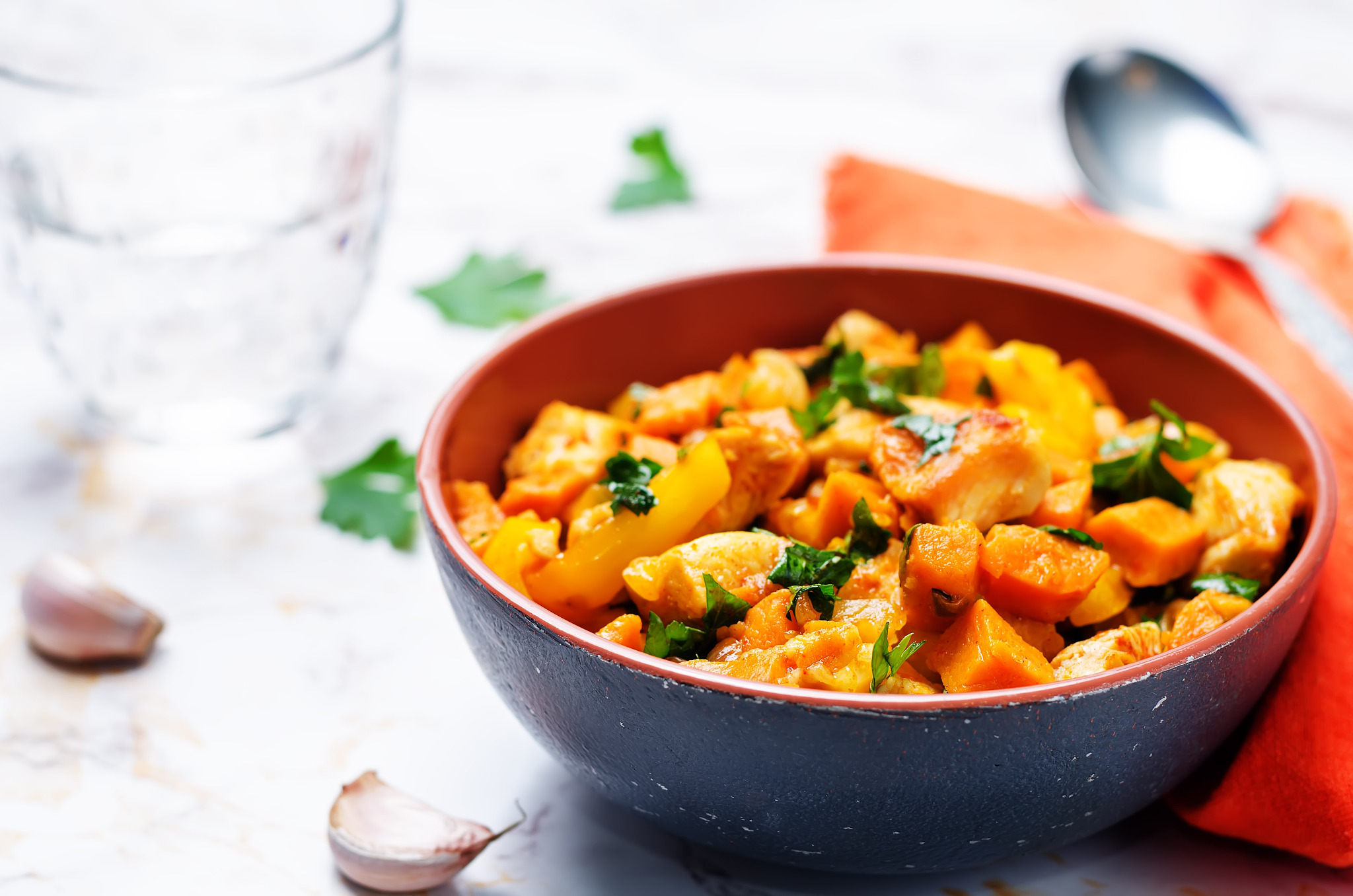 sweet potato chicken skillet with glass of water