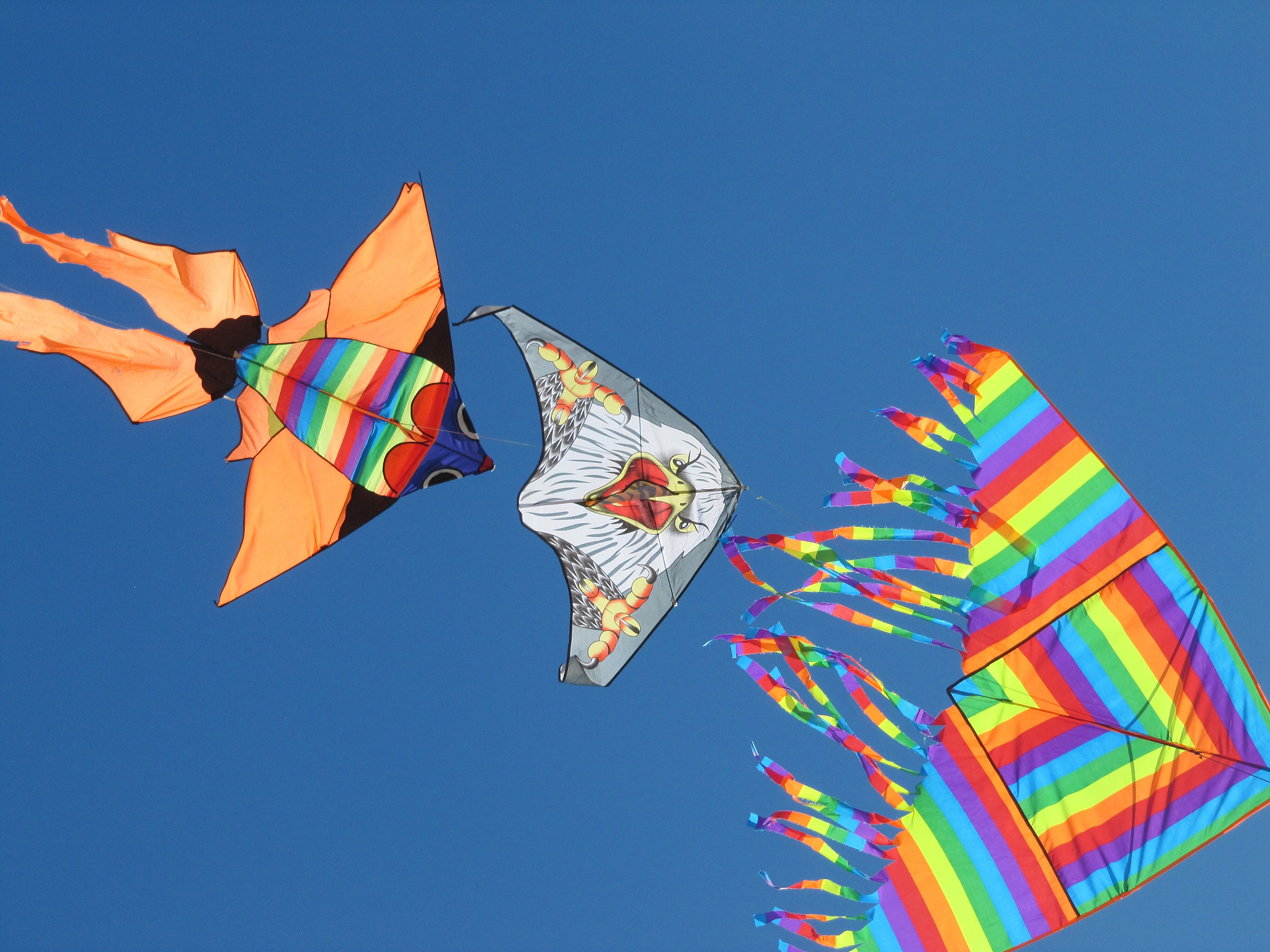 low angle view of kites against clear blue sky