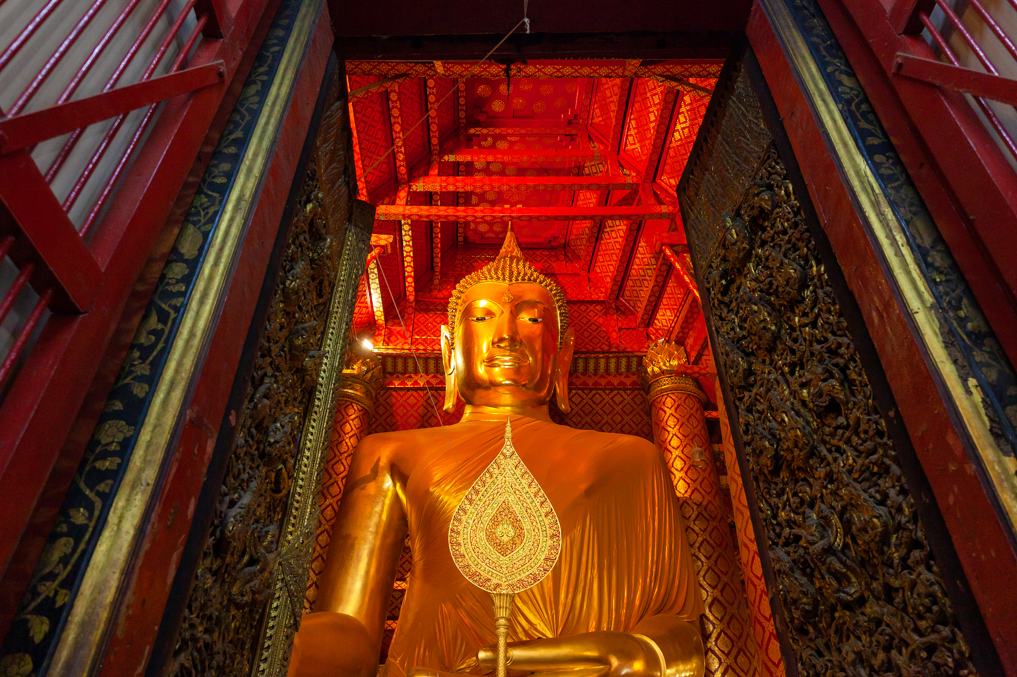 golden buddha statue located in the temple of ayutthaya, thailan