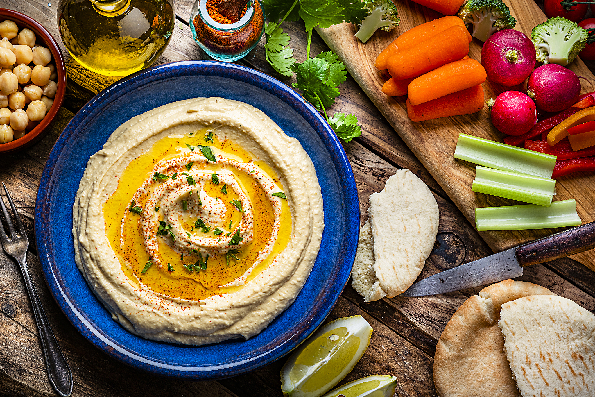 vegan food: hummus in a plate with vegetables and pita bread