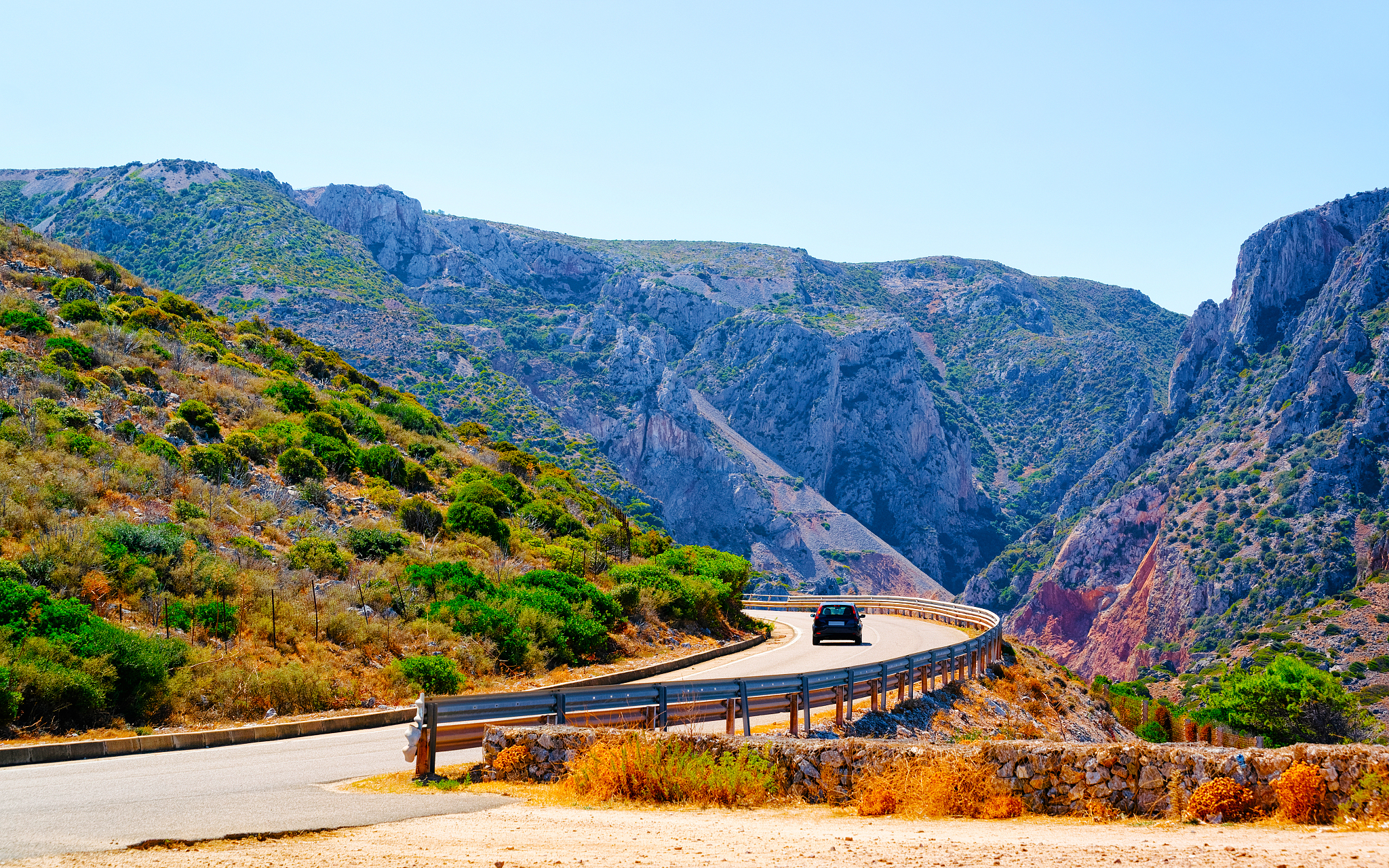scenery with car at highway in cagliari in sardinia hills reflex