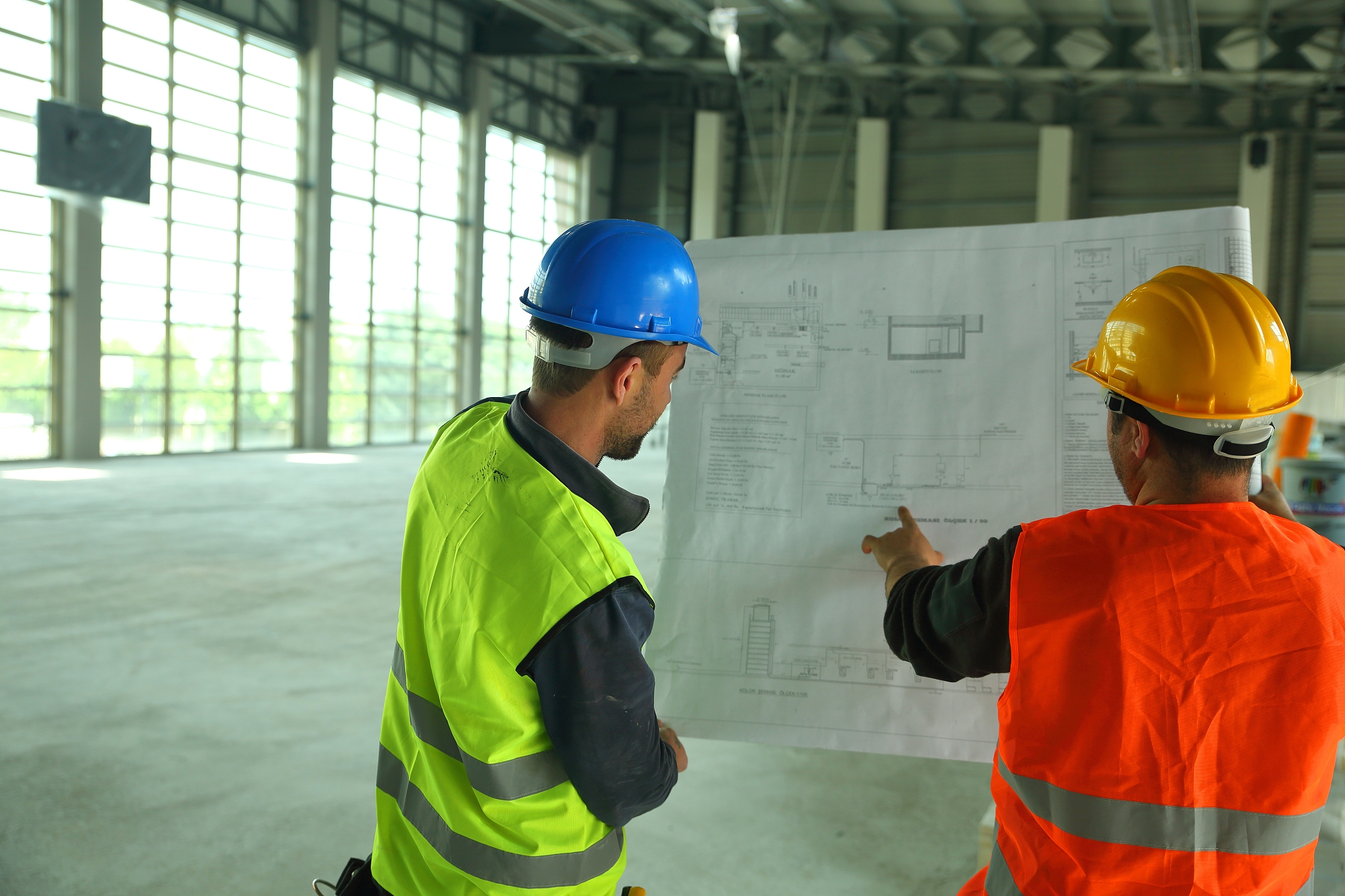 construction workers reading blueprints