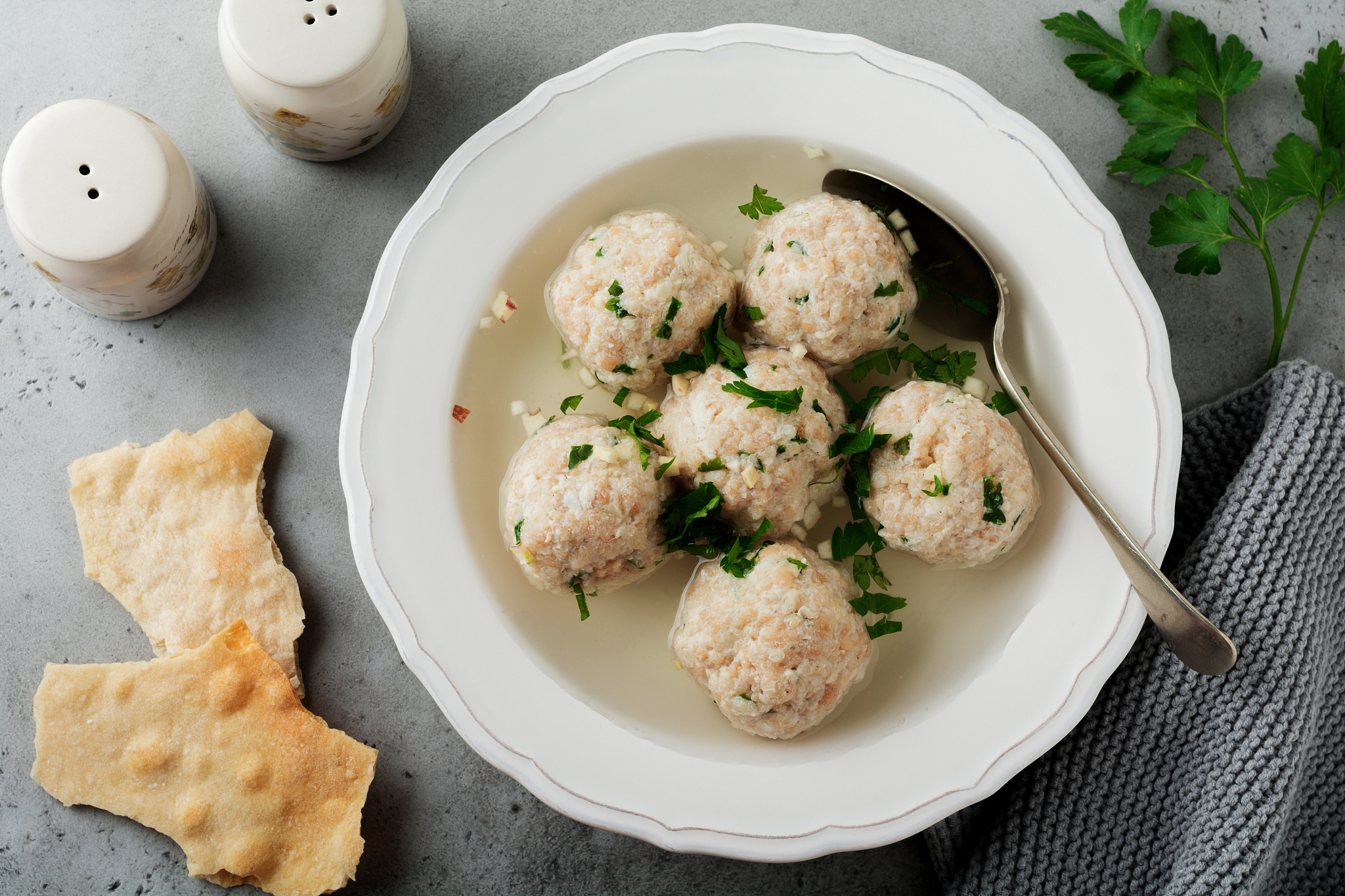 homemade chicken matzo ball soup with parsley and garlic in simp