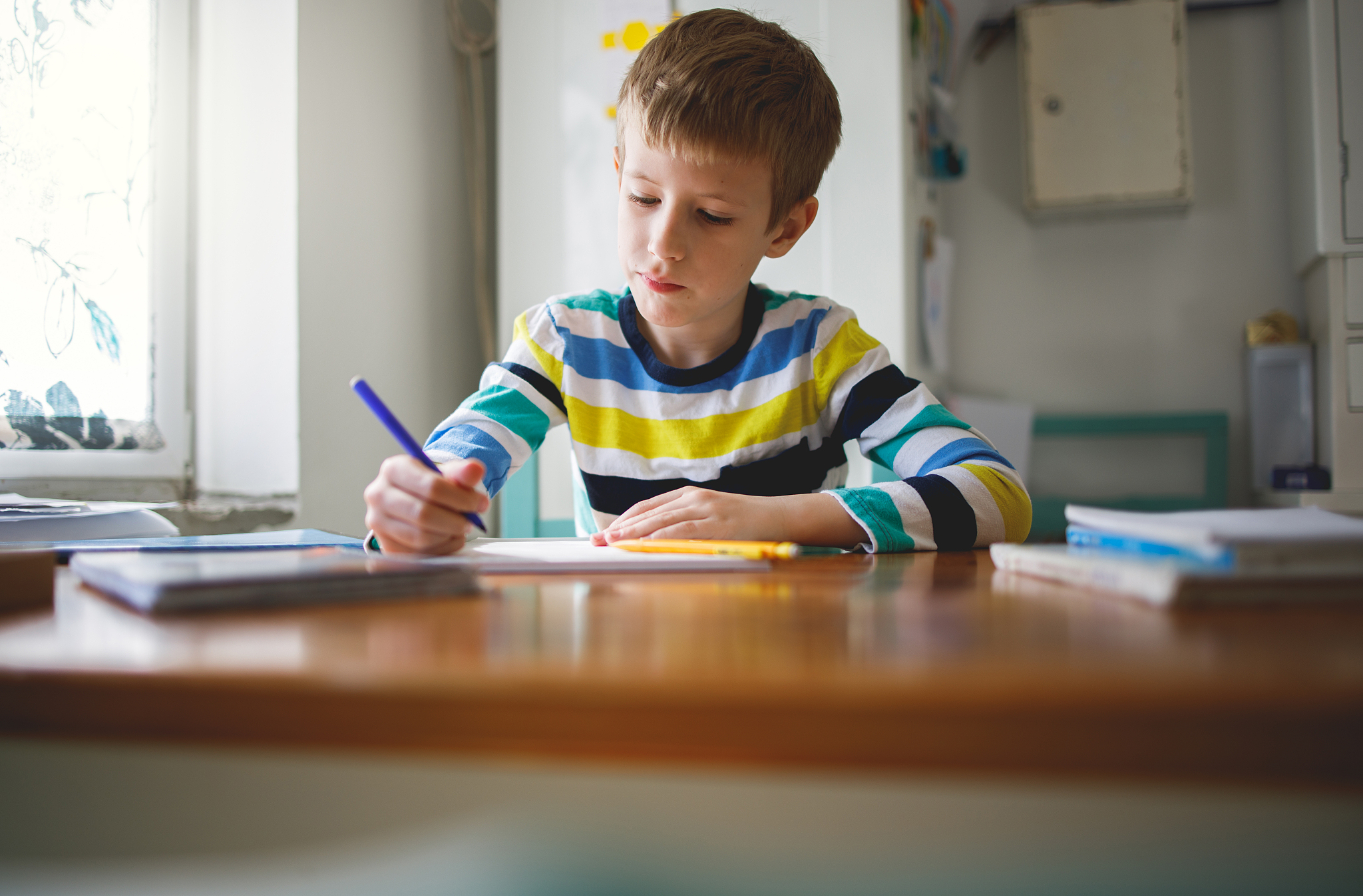 young boy learning at home