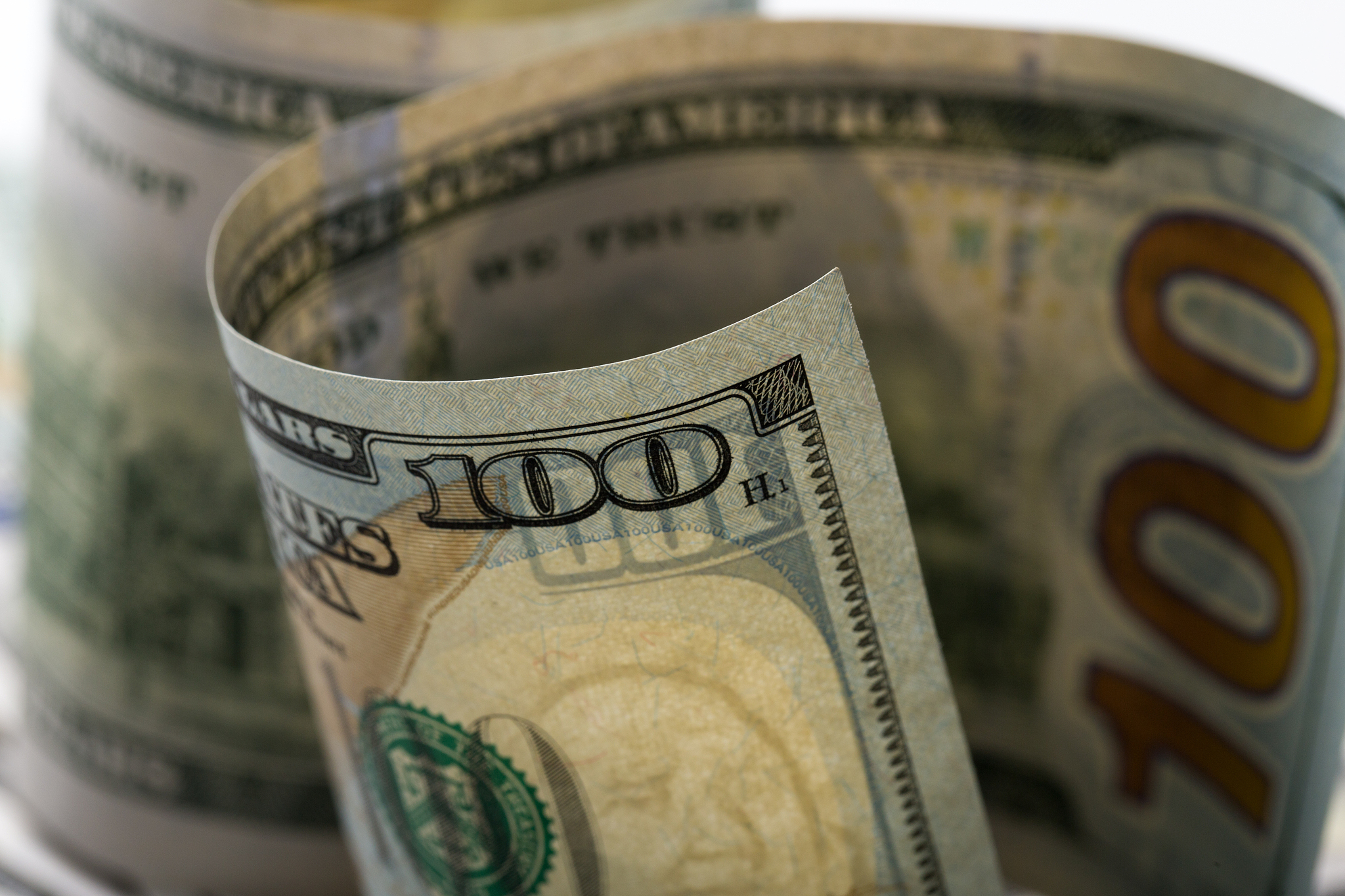 american dollars. a stack of hundred dollar bills. close up of n