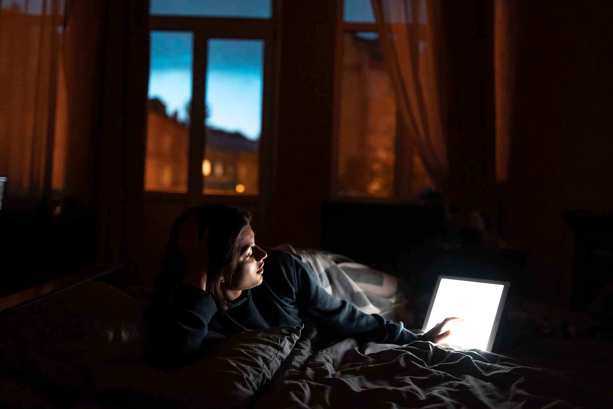 close up to view woman's hands hold tablet with empty screen.