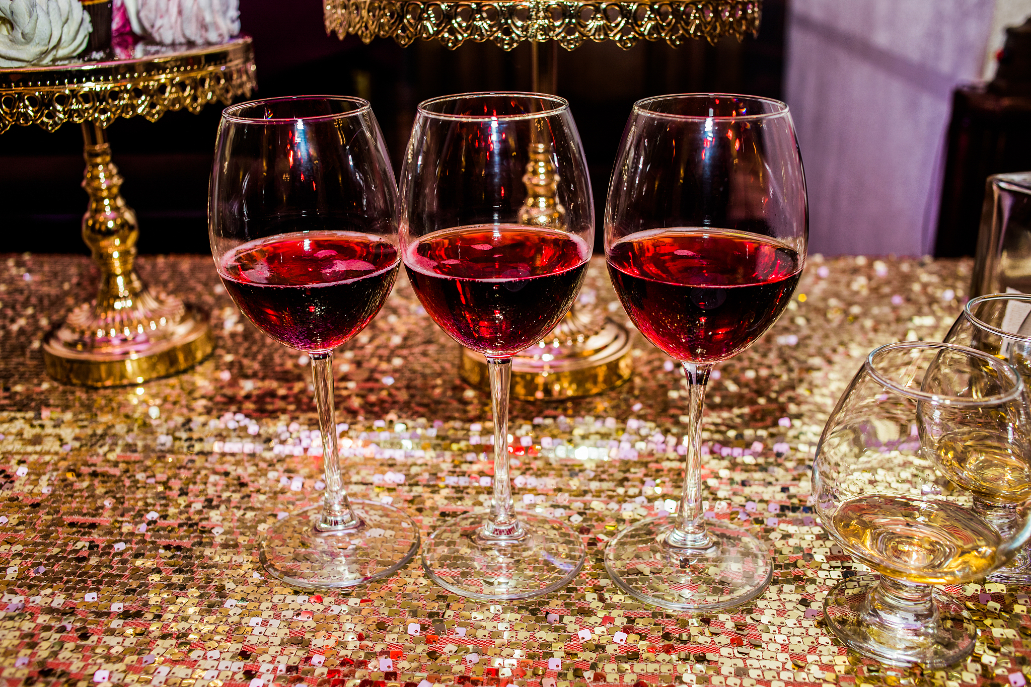 candy bar. three glasses are full of wine