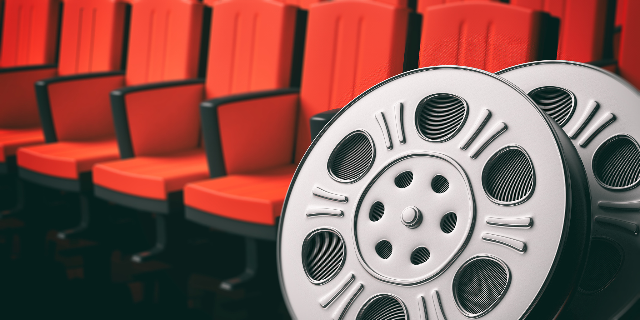 film movie reels with blurry red theater seats background, copy 