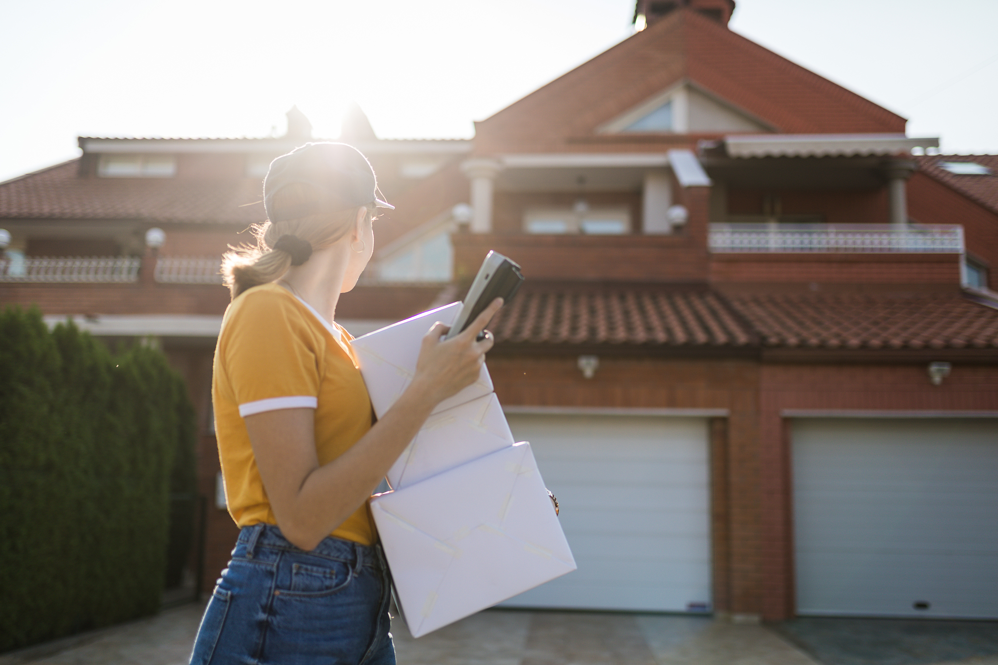 postal worker searching for a delivery house