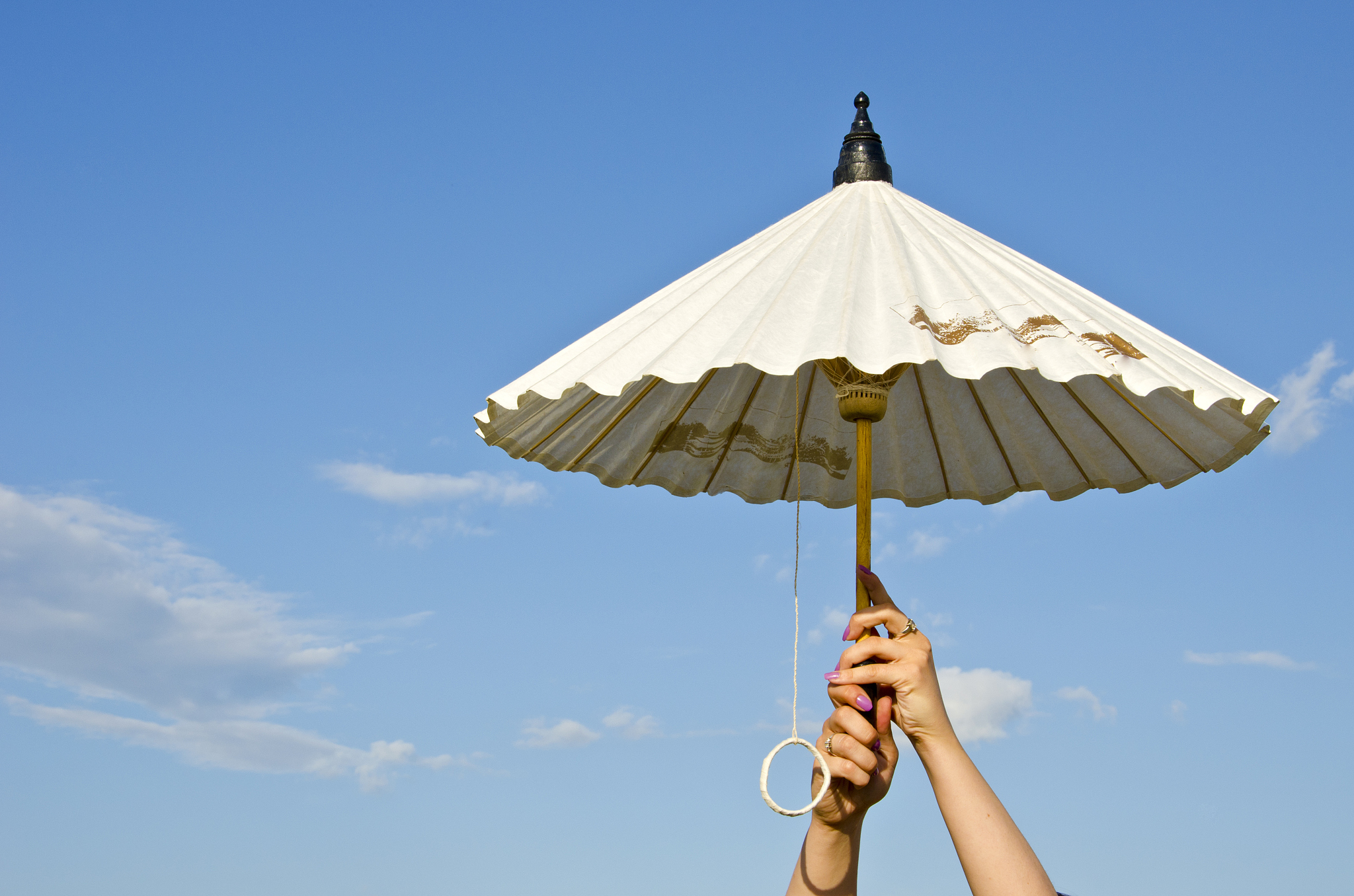 girl hands holding paper umbrella