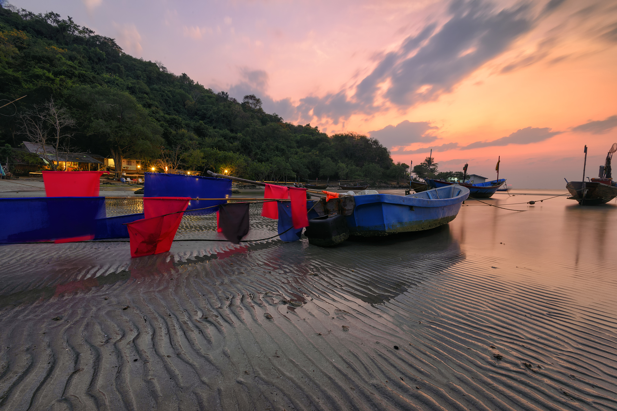 boats at the beach during sunset