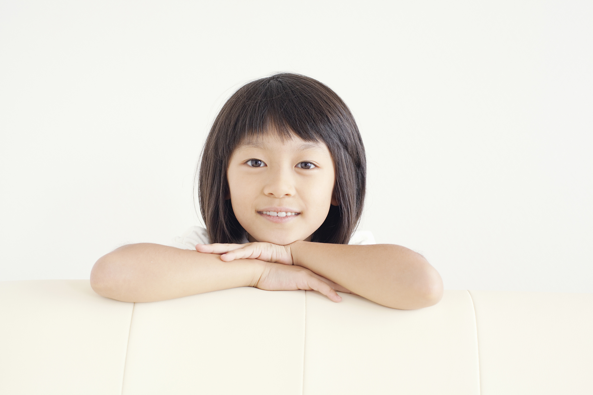 girl hiding behind sofa