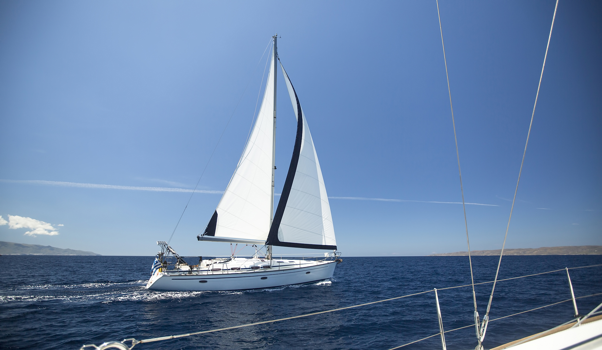 ship yachts with white sails in the open sea.