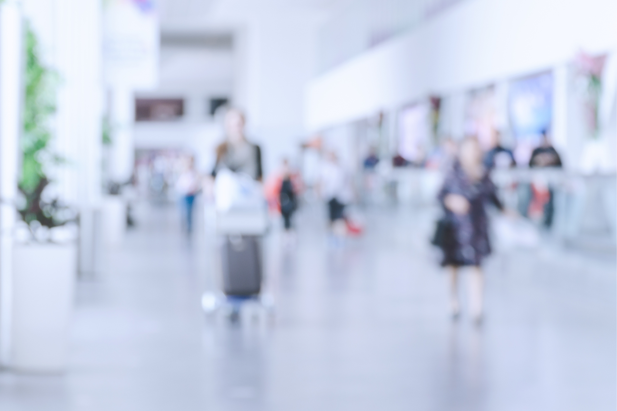 blurred photo with people at airport, defocused silhouettes indo