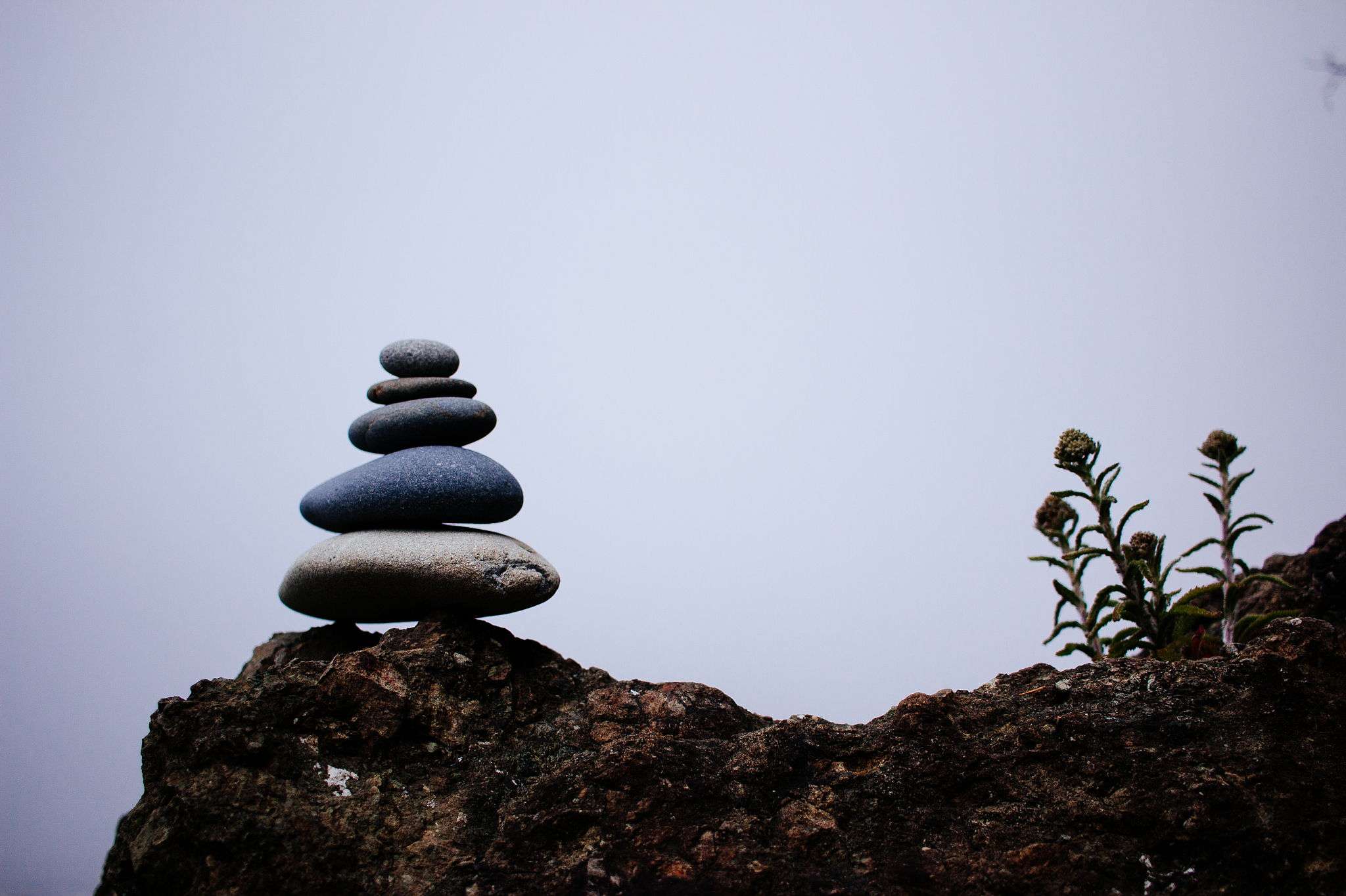 stack of stones on rock against clear sky