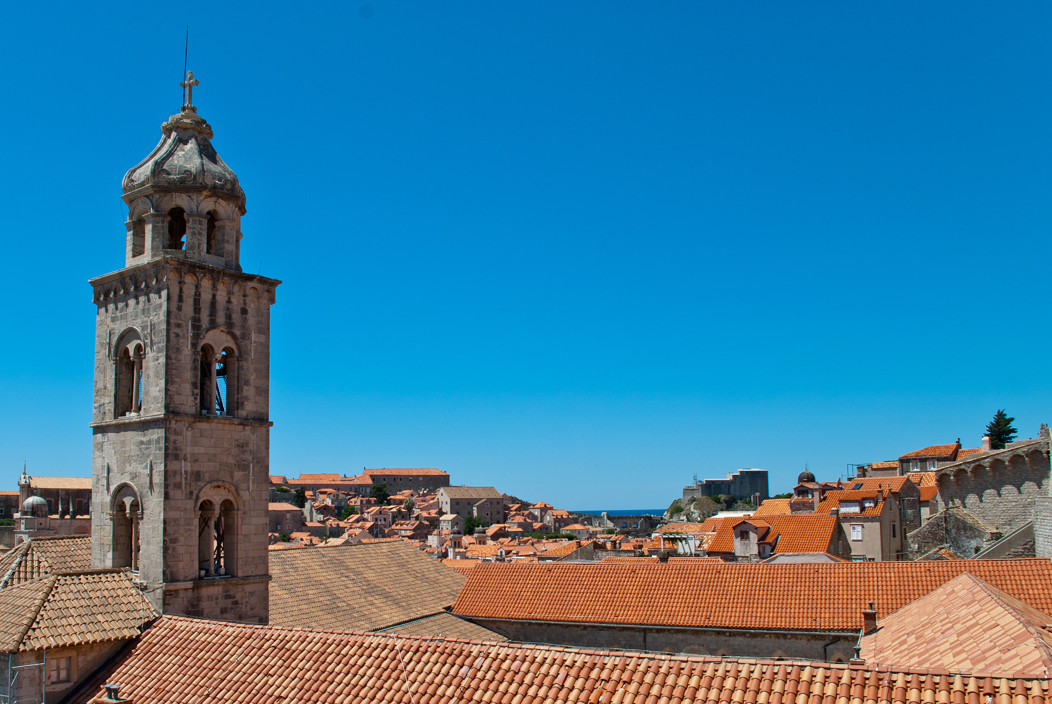 view of dominican monastery in dubrovnik with slim tower inside 