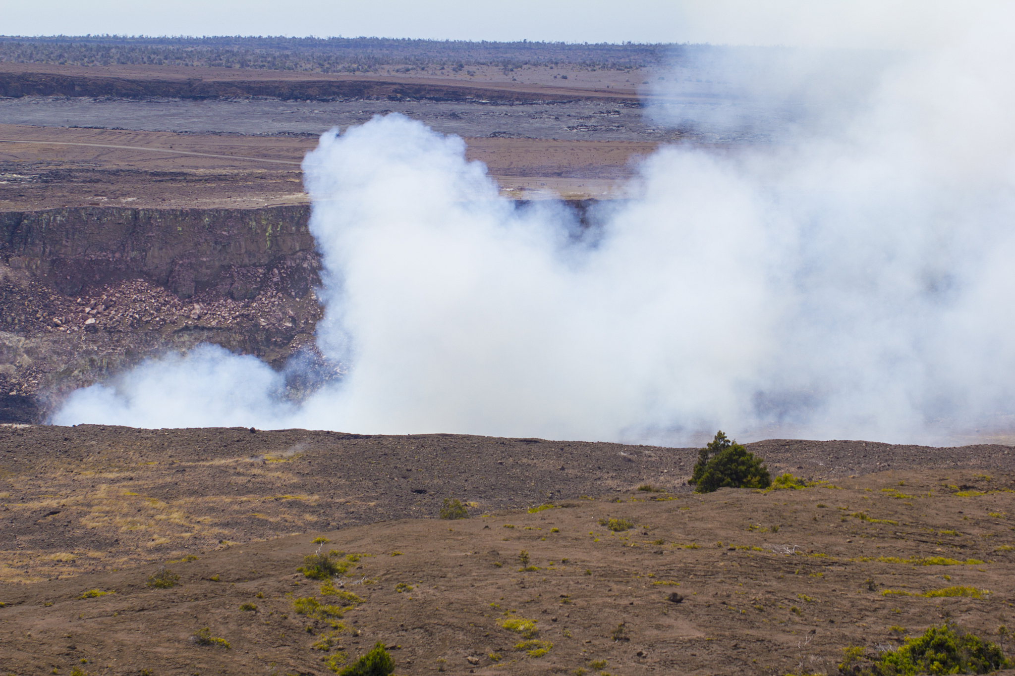 landscape picture with billowing smoke coming from crater.
