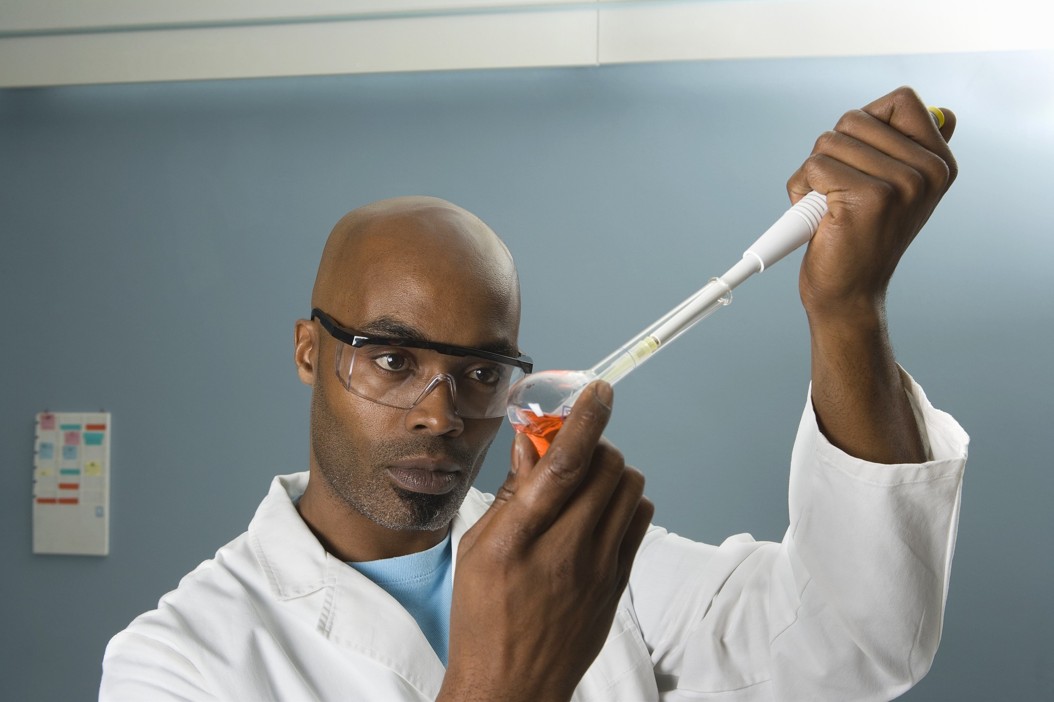 technician measuring sample with pipette