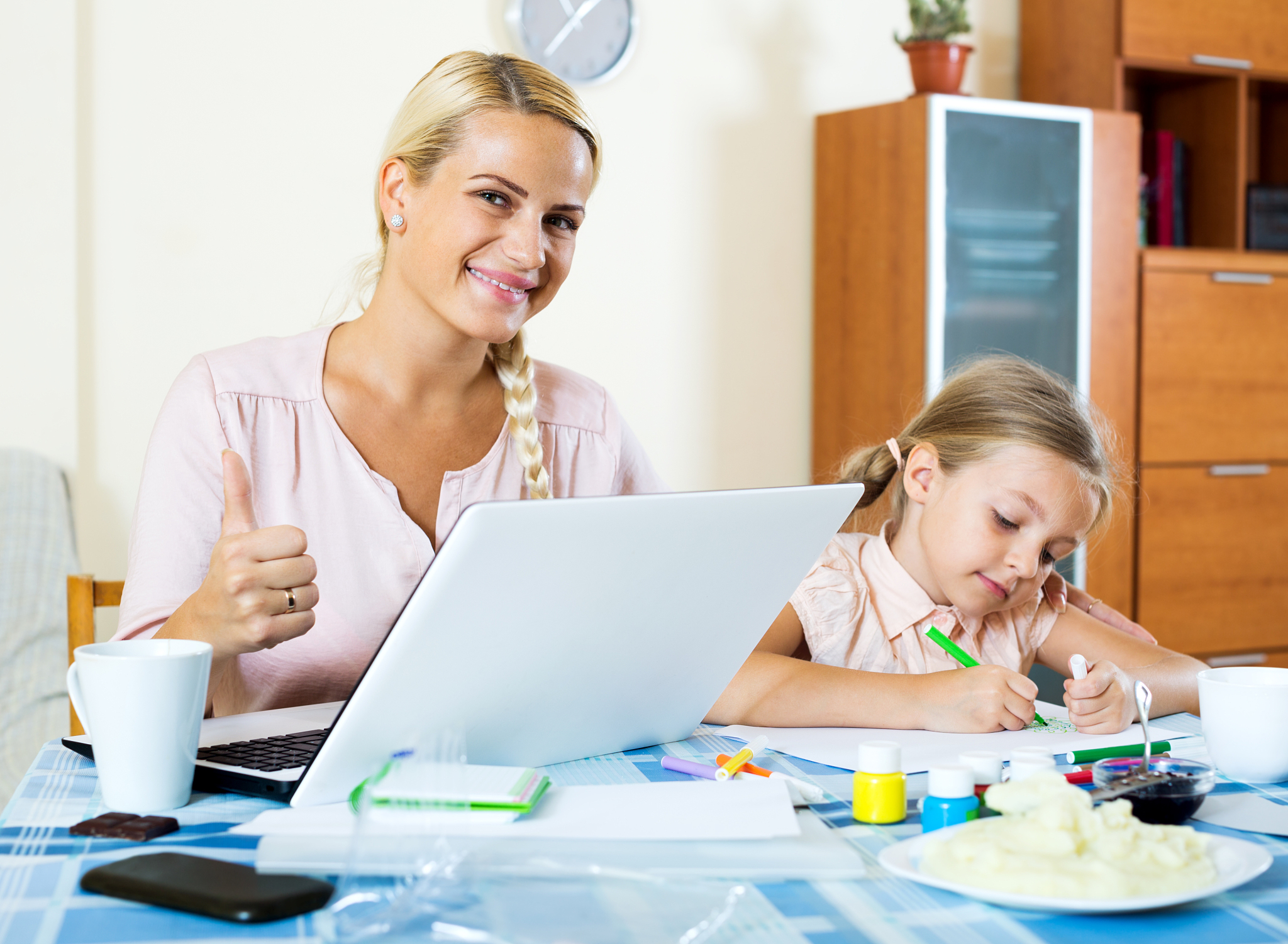 successful woman with daughter working