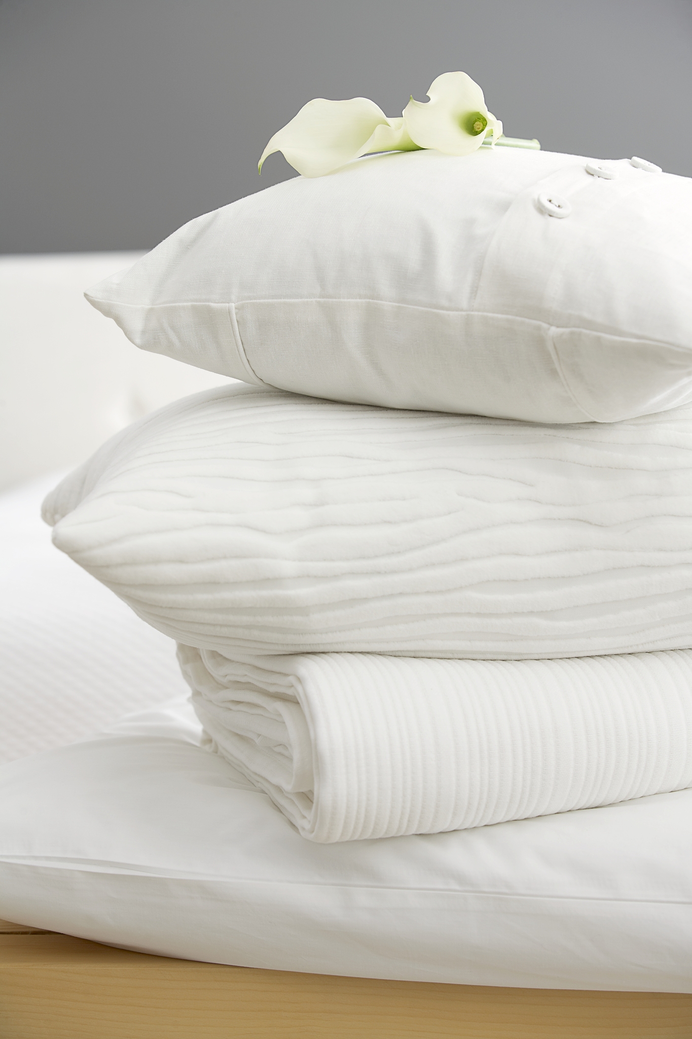 stack of pillows and blanket