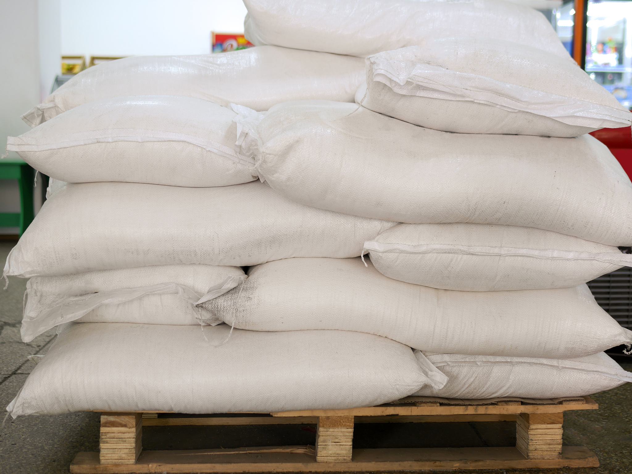 sugar in bags, stacked on wooden pallet