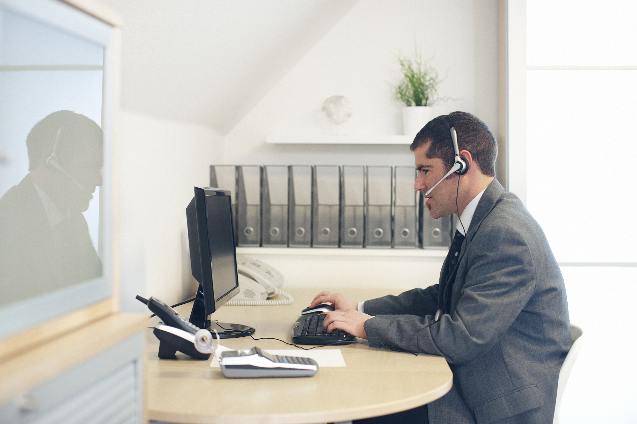 customer service agent on phone in front of computer