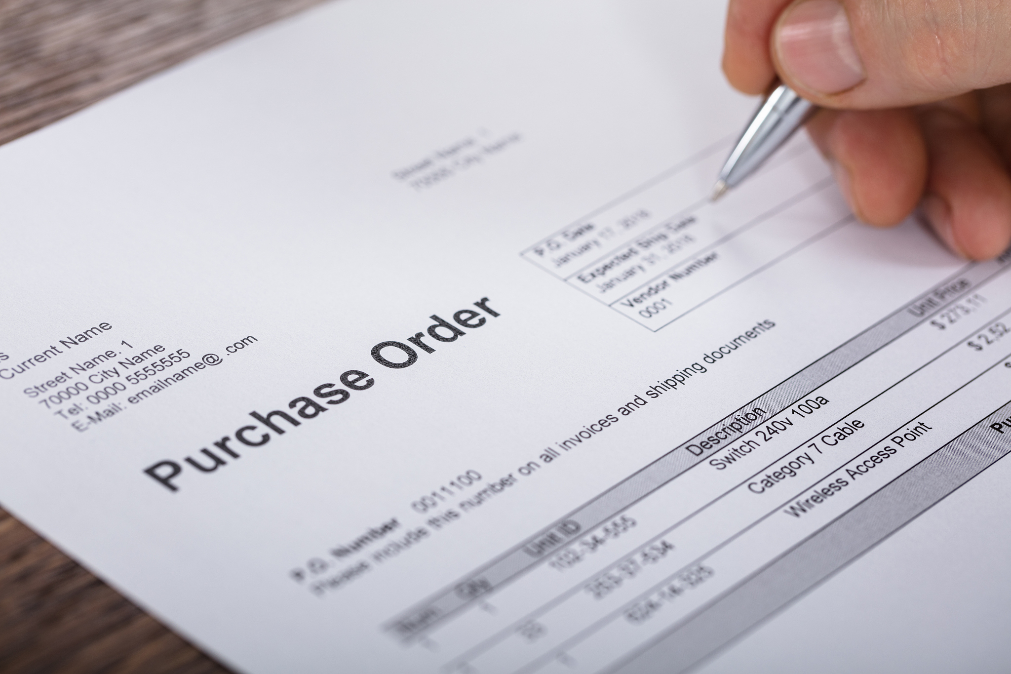 person filling a purchase order form