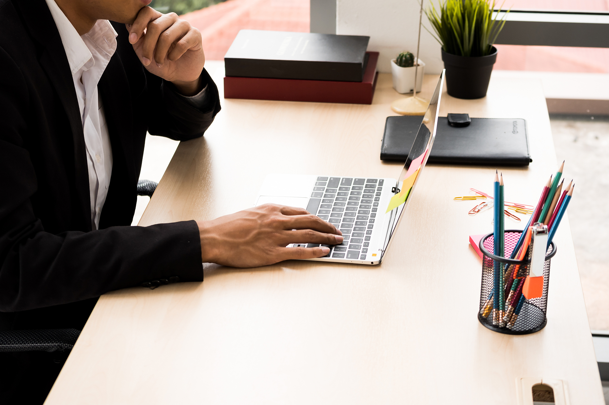 businessman is reading information about work from laptop at the