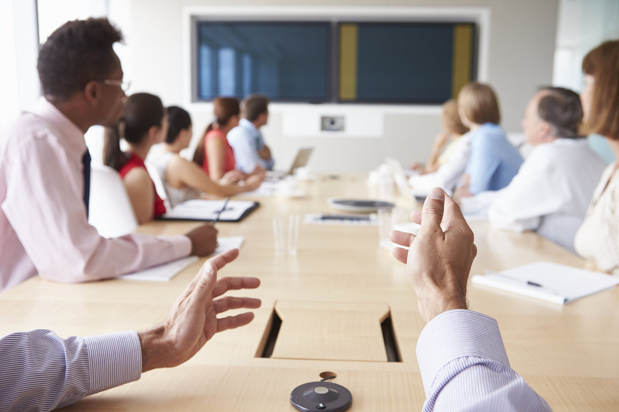 point of view shot with businesspeople around boardroom table